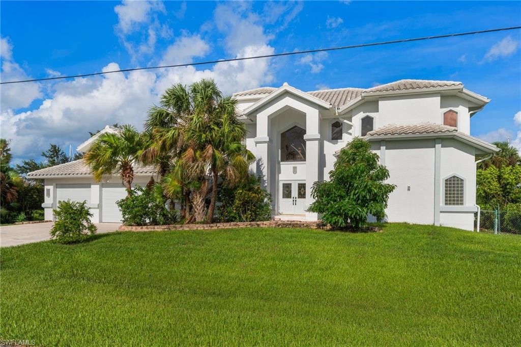 Updated SAILBOAT ACCESS pool Home! Investment Opportunity. Experience the ultimate in waterfront lifestyle just minutes to Charlotte Harbor and the Gulf with no bridges to open water, on an oversized, deep water lot. Perfect for larger vessels and yachts, the property features an 80-foot DOCK with a lift and room for multiple boats. Step inside nearly 4,000 sq. ft. of living space, where soaring ceilings and natural light highlight the open concept design. A grand Bamboo wood spiral staircase sets the tone the moment you enter and continues throughout the second level. The gourmet kitchen is a chef’s dream, showcasing sleek countertops and top-of-the-line appliances, ideal for both everyday living and entertaining. Propane cooktop. The renovated primary suite boasts a spa-inspired bathroom with a custom shower, soaking tub, dual sinks and designer lighting. Additional bathrooms have also been beautifully updated with modern finishes, and new porcelain tile. Oversized 3-car garage. Whole-house generator & underground utilities Multiple A/C units and mini splits. Relax by the pool, host guests or set out on the open water. The choice is yours. Located between Sarasota and Fort Myers, with easy access to US-41AND I-75. Approximately 10 miles from Punta Gorda airport. Port Charlotte is a boater’s paradise, within close proximity to beautiful Gulf beaches and waterfront destinations throughout Southwest Florida. Whether you are seeking a full-time residence, seasonal escape or investment property, this one-of-a-kind waterfront retreat delivers the luxury, comfort and convenience you’ve been searching for. Living room, Family room and first floor primary suite photos have been virtually staged.