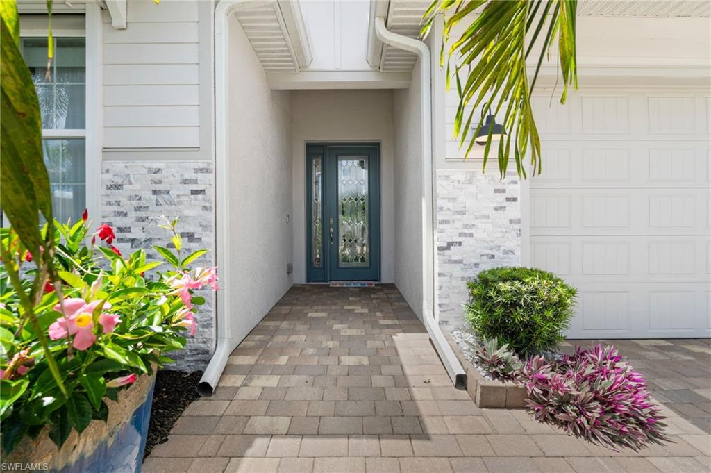 Coastal luxury meets exceptional upgrades in this gently used waterfront SHELBY model at Seasons at Bonita. This beautifully maintained 3 bedroom + DEN, 2 full bath PLUS 2 half bath home offers a highly desirable open-concept layout, water views, and a rare, tandem 3-car garage with built-in storage. Used ONLY as a seasonal residence, the home feels barely lived in and showcases thoughtful builder AND aftermarket upgrades throughout.
From the moment you arrive, the home stands out with its unique and stone-accented elevation, upgraded glass front entry door, and welcoming foyer filled with natural light. Inside, you will love the oversized wide-plank luxury tile flooring, crown molding, tray ceilings, upgraded lighting, Minka fans, Graber thermal privacy shades, and a cohesive coastal-inspired design palette. 

The kitchen is light, bright, and beautifully upgraded with quartz countertops, upgraded cabinetry, and pearl-accented backsplash, and a spacious island, and creating an easy flow into the dining and great room areas. 

Triple sliding glass doors open to the screened lanai, creating the perfect indoor-outdoor living experience while capturing peaceful water views. The lanai is plumbed for an outdoor kitchen and features Storm Smart hurricane shades for added comfort and protection. (Storm Smart shades are on EVERY window of this home!)

The private primary suite offers a relaxing retreat with water views, upgraded finishes, and a spacious bath with a combination of both walk-in shower PLUS jacuzzi tub! No detail was overlooked in this home.. An oversized, walk-through closet with custom built-in organizers provides ample space for his, hers and MORE.

The true den provides flexible space for a home office, hobby room, or an additional guest room. Guests will appreciate the split-bedroom layout, while the cabana bath and additional half bath add everyday convenience and functionality.

Additional highlights include an epoxy-coated garage floor, built-in garage storage, newer HVAC and water heater, and a location in an X flood zone. Every system in this home has been regularly maintained by the owners -- including flooring, (i.e Stanley Steamer.)

Seasons at Bonita offers resort-style amenities including a clubhouse, resort pool, fitness center, tennis, pickleball, bocce, dog park, and more — all in a prime Bonita Springs location near shopping, dining, beaches, and the future Midtown at Bonita.

This home may lack a pool, (although, there is PLENTY of room for one) but it more than makes up for it with extensive upgrades, thoughtful storage, cohesive finishes, peaceful water views, and barely lived-in condition.