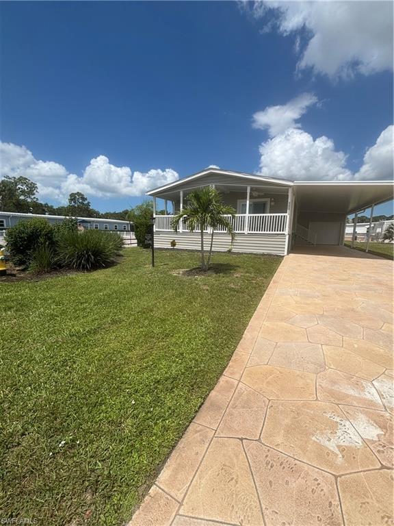 Move-in ready 2019 manufactured home located in Imperial Bonita Estates! This furnished 2-bedroom + den, 2-bath residence offers approximately 1,364 square feet of living space with an open great room floor plan designed for comfortable everyday living and entertaining.

The spacious kitchen features an island, ample cabinetry, and comes equipped with a range, microwave, refrigerator, dishwasher, washer, and dryer. Hard floors flow throughout the home, and impact-resistant windows provide added peace of mind. The primary suite includes an accessible shower, while the versatile den offers space for a home office, hobby room, or additional sitting area.

Enjoy Florida living on the open lanai and take advantage of the attached carport, paved driveway, and the convenience of an electric vehicle charging outlet located in the carport. Situated on a corner lot within the Imperial Bonita Estates cooperative community, residents have access to amenities including a community pool, clubhouse, pickleball, tennis courts, bocce, shuffleboard, and a dog park.

Conveniently located near shopping, dining, beaches, and Southwest Florida attractions, this property offers an opportunity to enjoy an active Florida lifestyle.