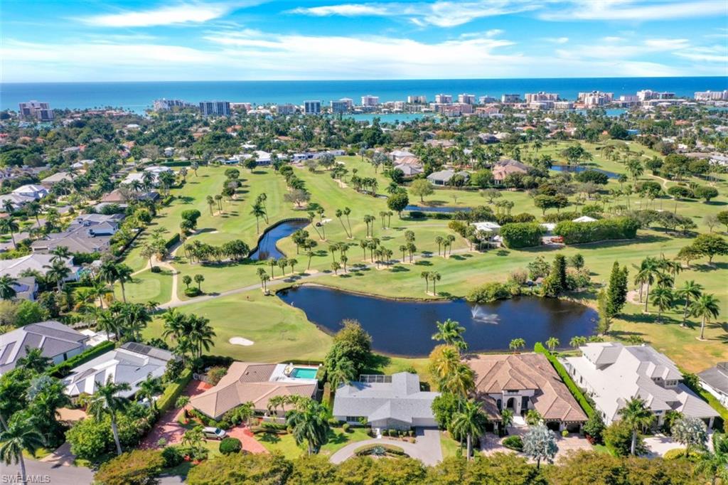 An outstanding property that offers a rare panoramic trifecta of unobstructed golf, lake, and sunset views.  Located on a quiet part of Wedge Drive, this X-500 zoned property overlooks a tranquil lake & fountain with long west facing views across The Moorings Country Club golf course. It features a bright and open 4 bedroom, 3 full bath original Moorings home, with both living and family rooms, and spacious covered lanai.  This great property offers the new owner a complete range of options—move in as-is, renovate, or build your dream home on this magnificent lot. Centrally located, the property offers private beach access through The Moorings Property Owners Association, and is minutes to both downtown Naples and Venetian Village.