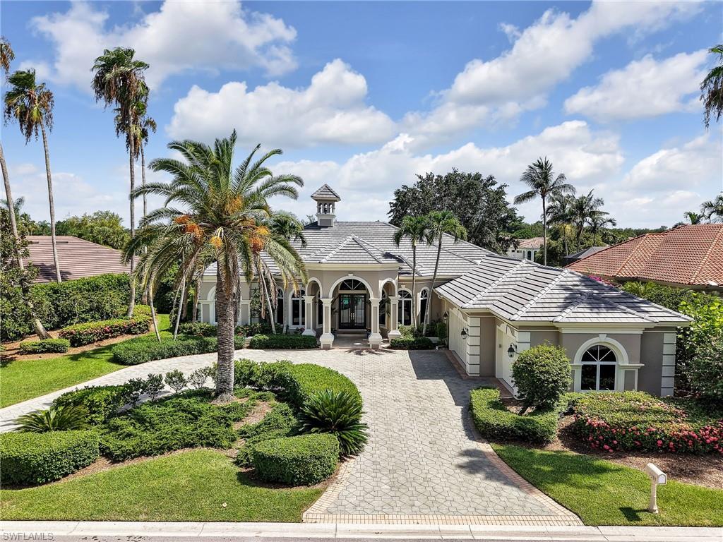 One or more photo(s) has been virtually staged, AI generated or rendered.  Rarely available in the Arbors at Pelican Marsh, an intimate enclave of estate homes inside one of North Naples' premier gated golf communities, where homes seldom reach the market. This beautifully maintained four bedroom plus den residence offers nearly 3,800 square feet of living space on a private .46 acre homesite with breathtaking southwest facing lake and golf course views.

Every bedroom includes its own private en suite bathroom, with one serving as a convenient pool bath. The private den, complete with a closet, flexes easily into a home office or fifth bedroom. The expansive screened lanai features a heated pool and spa positioned to capture sunset exposure over the lake and fairways, true indoor outdoor Florida living made for entertaining.

Recent improvements include a new tile roof (November 2024), fresh interior and exterior paint, updated door hardware, and new light fixtures throughout much of the home. Inside you will find custom woodwork, decorative tray ceilings with crown molding, soaring volume ceilings, French doors, and a rare wood burning fireplace.

The spacious kitchen is built for gathering: warm wood cabinetry, center island, tile backsplash, breakfast bar, pantry, and abundant counter space. The oversized primary suite offers a sitting area and a luxurious bath with dual vanities, jetted soaking tub, bidet, and separate shower. Additional highlights include a circular driveway, an oversized three car garage, a dedicated air conditioned storage room, and a spacious laundry room with upper and lower cabinetry. Select photos are virtually staged.

Pelican Marsh is a gated North Naples community just 1.5 miles from Gulf beaches and Vanderbilt Beach, minutes to Mercato, Waterside Shops, Artis Naples, and exceptional dining. Residents enjoy over 130 acres of nature preserves, miles of walking and biking trails, tennis, pickleball, bocce, a state of the art fitness center, spa services, and optional membership to the private Pelican Marsh Golf Club. Please use the entrances to neighborhood off of Airport Pulling and Vanderbilt Beach only for now. The Tamiami/US 41 entrance is being redone. This would be the normal entrance used for this home and location within the community.