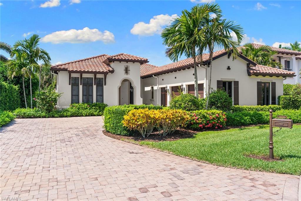 Set within Traditions at Grey Oaks, this elegant residence offers immediate golf membership eligibility, providing the rare opportunity to bypass the club's multi-year golf membership waitlist. Offering a spacious single-level floor plan, the home is enhanced by soaring ceilings, rich architectural detailing and effortless indoor-outdoor living. Three generously sized bedrooms plus a large den, three full baths and one half bath are thoughtfully arranged among expansive gathering spaces designed for everyday living and entertaining. An attached 2.5-car garage, including a dedicated golf cart bay, provides exceptional convenience for the Grey Oaks lifestyle. Architectural details, including exposed wood beam ceilings, dramatic tray ceilings and custom millwork, add warmth, dimension and timeless character throughout. The spacious kitchen features an oversized island, natural gas cooking and abundant cabinetry, while the flexible floor plan offers various uses. Expansive screened lanai, where a generous covered outdoor living area, built-in grill, pool and lakefront setting create an ideal environment for relaxing or entertaining. Located on the main clubhouse side of Grey Oaks, residents enjoy one of Naples' premier private club lifestyles with three championship golf courses, two elegant clubhouses, multiple dining venues, driving ranges, a resort-style pool with lap lanes, a 30,000-square-foot wellness center with spa services and fitness classes, tennis, pickleball, bocce and a vibrant calendar of social and wellness activities.