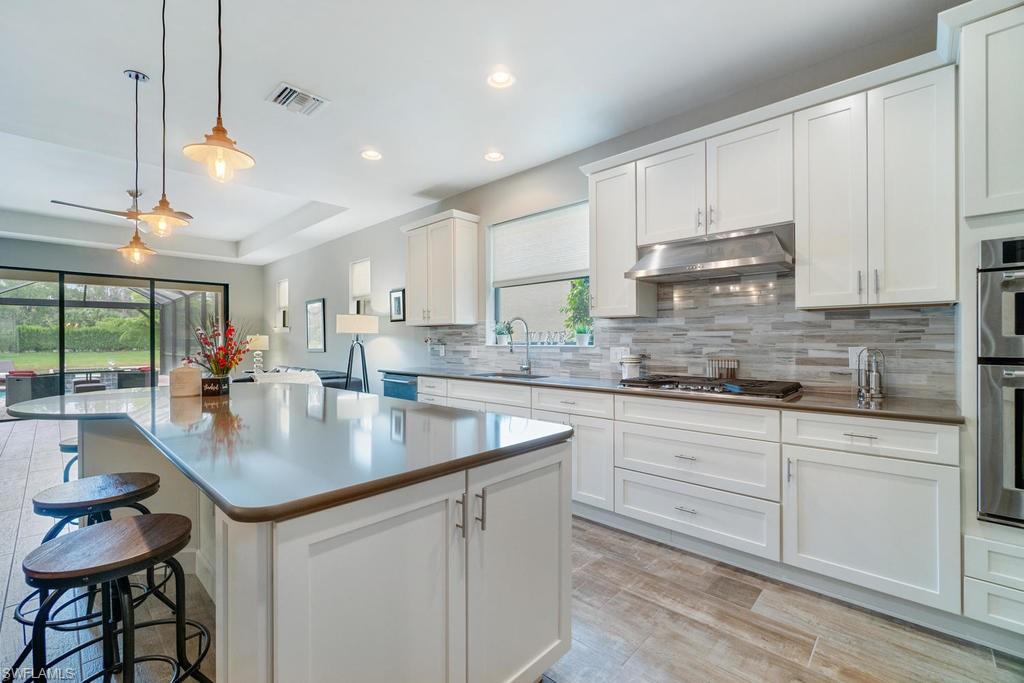 Stop looking because this is it! This 3 bedroom, den, 2 bath home in the natural gas community of Camden Lakes has a stunning salt-water pool with fire feature & spa. Your expansive lanai with panoramic screen provides an unobstructed view of the tranquil lake setting & is stubbed with gas & water to create the perfect outdoor oasis. The chef in you will love the deluxe, gourmet kitchen with all top of the line Kitchen Aid appliances including a 5 burner gas cook top, double wall ovens, French door refrigerator, & wine cooler. Relax in your spa-like master bath featuring oversized shower and decorator finishes. Wide-planked, wood finish tile & neutral paint complete the coastal feel of your beautiful, like-new home. You'll never run out of space for your toys & belongings with the extended garage & expanded attic storage. Zoned for all A-rated schools: Veterans Elementary, North Naples Middle, & Gulf Coast High. You've found your new home, the only thing it's missing is YOU!
