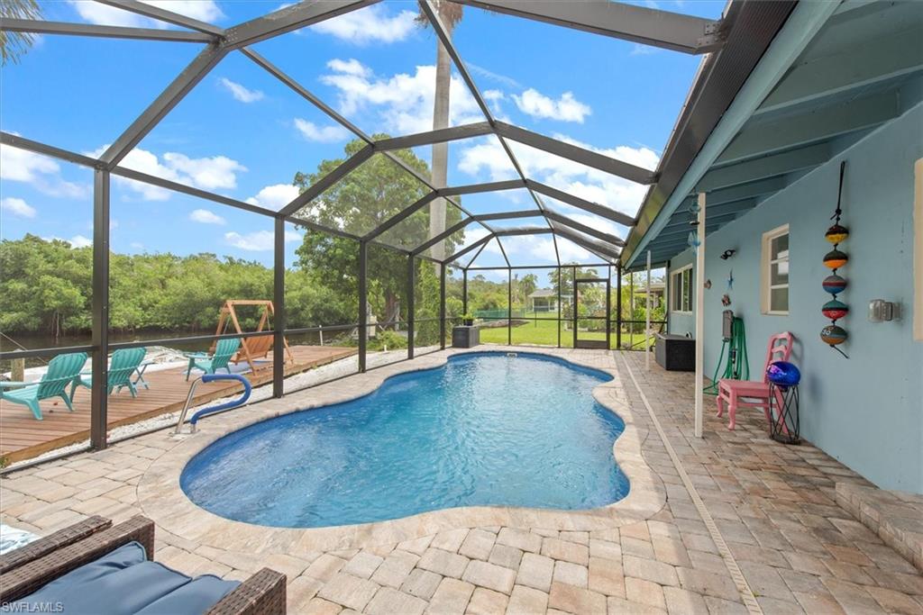 LOOKING FOR EXTRA ROOM?   This 2,767 sq ft under-air property offers QUICK direct access to the Intracoastal Waterway right from your backyard. Perfect for boaters, fishing enthusiasts, and nature lovers. Enjoy watching the endless of the manatees right from your back yard!  This expansive property eliminates the hassle of bridges, providing a seamless and quick journey out to the Gulf. Inside, the generously sized floor plan boasts massive living spaces.  BONUS! Newer Salt water heated Pool and air conditioner added in 2022, along with all new kitchen appliances, cabinetry and quartz countertops.
4 bedroom plus den offers additional flexibility!  The extra large den offers a private suite for guests, and could possibly be transformed into a separate living quarters. Whether you are looking for a private retreat or the ultimate entertainment hub, this expansive waterfront home delivers location, and lifestyle you have been searching for. This home is located in the highly sought after Yacht Club Colony which boasts it's own community boat ramp, gazebo for entertainment, community gatherings, park benches, fire pit, play a game of horseshoes,  bring your golf cart, ride your bike, or simply walk to the point for the most spectacular sunsets, or watch the yachts, sail boats, or fishing boats passing by.  Just minutes to waterfront restaurants, by boat or car, Enjoy the many happenings of downtown Fort Myers, and living Close to I-75 makes it an ideal location. 
Close to two airports, shopping and so much more! 
Priced right for the extra love needed for roof repair or replacement (no known leaks)