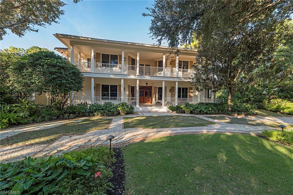 This Old Florida-style estate home resides on one of the most private, serene settings in all of Grey Oaks. The rarely available double homesite measures over one acre including 280 feet of lake frontage with panoramic preserve and double fairway views of the Pine golf course. The wrap-a-round front and rear verandas allow for ideal indoor/outdoor Florida living. This estate's private tranquil gardens are reminiscent of a bygone era. The four-bedroom-plus-study, six-and-one-half bath home includes a screened-in pool with raised spa and separate pool cabana ideal for entertaining friends and family.  Located just minutes from world-class dining, shopping and beaches of Old Naples, the award winning Grey Oaks Country Club has recently completed a multi-million dollar renovation including an incredible new lagoon beach entry pool, fire pits, indoor/outdoor restaurant and bar, tennis center, golf training facility and a future 30,000 square foot lavish health and wellness center.