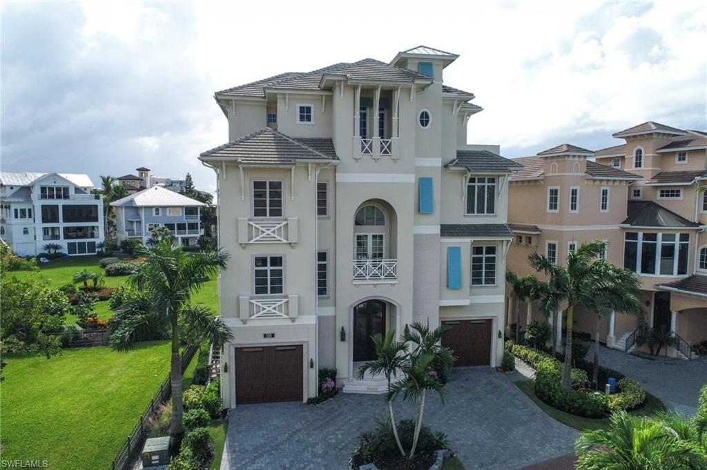 Stunning custom beach home. Recently completed luxury residence that is situated on a lot and a third direct SW exposure gulf front lot in the largest of all the Barefoot Beach gardens. This 4-Story home offers a wide open feel on all levels due to the high quality of construction and has been professionally appointed top to bottom in an elegant coastal style. Layout includes 5 bed suites, his and her office space, top level cloud entertaining, and beach living and bar with 9 total baths. Includes grand wood staircase, elevator, high end gas appliances, electric screens, tasteful wide plank oak flooring, and large sit up butcher block kitchen island. Home also includes gas generator. Concrete and impact glass construction. Smart home lighting and numerous wet bars throughout. Includes heated pool, landscaped beach grounds, beach boardwalk, private clubhouse with fitness, tennis, and pickle ball.  24 hour patrolled security. Closest beach to international airport convenient to both coconut point and Naples entertainment.