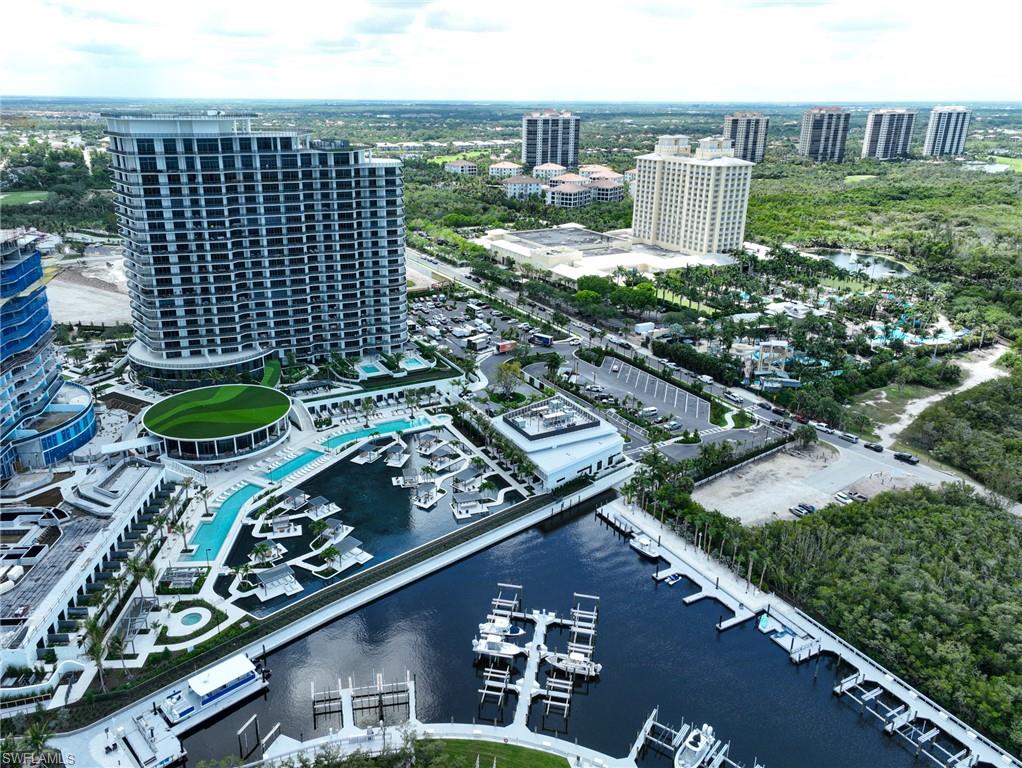 Rare opportunity to purchase one of only two condomiums with its own private pool and summer kitchen with gas grille in the just completed Ritz Carlton Saltleaf Residences located right on Estero Bay. No wait - amenities are complete and open. With 2628 AC SQ FT and approximately 5500 Total Sq FT of living this new light coastal contemporary condo features an open floor plan with kitchen open to the dining area and great room and all over look the covered lanai, swimming pool. The state of the art kitchen features Italian contemporary Cabinetry, Wolf natural gas cooktop and ovens, Subzero Refrigerator and Subzero full size wine cooler, large island and quartz countertops. The master suite has wall of sliders leading to the covered lanai and pool open deck. The spacious master bath includes a wall of cabinetry with his and her areas, large shower and free standing tub.  The master closet has upgraded closet cabinetry large enough for year round living. Guest bedroom features a large en suite bath with two sinks and an oversized shower. The den/flex room has a full bathroom adjacent to allow for multiple uses. All bathrooms feature Italian contemporary cabinets, and designer plumbing fixtures, flooring and wall tile. 
The elevator is conveniently located just outside the front door entry door and the two garage parking spaces are right near the elevator entrance with no cars next to them. The swimming pool has a large sun shelf, lots of landscaping and the ultimate summer kitchen for any condominium with covered and outdoor space totaling nearly 3000 SQ FT.  Sports & News Café (complimentary breakfast), Sunset Lounge and pool bar, Wine & Whiskey Lounge, catering kitchen and exhibition kitchen, and private dining room.  Lagoon with shaded pavilions, private cabanas (a limited number available for purchase), Card Room & Library, kids and teens rooms, sports simulator lounge, screening room, boardroom and private offices, garden pavilions with outdoor kitchens, firepits, bocce courts, fully staffed lobby lounge with mail and package rooms.  Fitness center with cardio and strength equipment, yoga and Pilates studios, steam room and sauna, salon and spa treatment rooms, three pools, whirlpools, dog park and pet grooming, as well as a community trail system. As a resident, you’ll have access to everything that’s best about the new coastal village of Saltleaf on Estero Bay. From your home, neighborhood trails can take you to challenging games at the new Saltleaf Golf Preserve, now open for play. Waterfront adventures at the 72-boat slip Saltleaf Marina, which is set to open mid-2026. The authentic Florida beauty of a 144-acre nature preserve. And Acqua Bistecca, a restaurant by Michael Mina, with cuisine that lives up to its breathtaking Estero Bay views.
All of this plus a central location with Coconut Point Mall 5 minutes away.