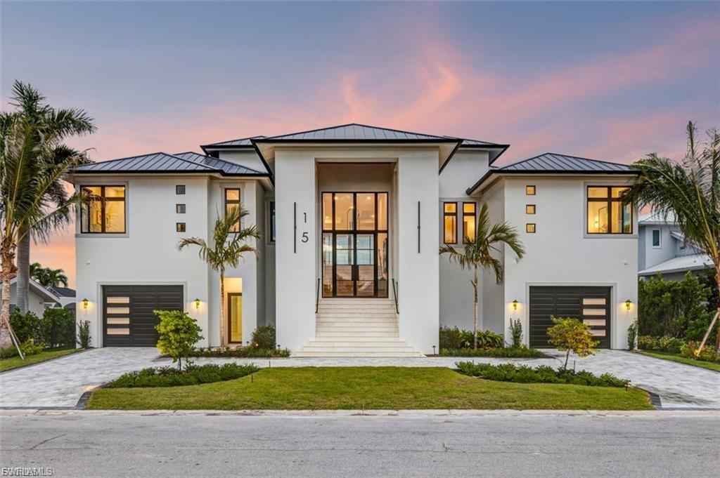 Elevated design, solid craftsmanship, and bold architectural authority. 15 Bayview Boulvard isn't just a home it's a Bayfront destination that sprawls across 4,000 sqft under air (over 10,000 sq ft total). This setting is not only private, it's located on a 100ft wide lot, overlooking the preserved island, and fun loving wild life enjoying their natural habitat. Completed in late 2025, this bayfront sanctuary offers open Gulf access with a 20,000 lb boat lift and delivers total privacy while remaining moments from waterfront dining, shopping, and entertainment. Peaceful— but never disconnected. This design is not coastal soft. Professionally designed with intentional movement between metal accents, multi tonal woods, and glass expanding throughout the space, the home announces itself with a grand entry and high-volume ceilings. The retractable glass walls along the Bay flood the interior with light and dissolve the boundary between inside and out. Volume. Texture. Intention. Designed for elevated living and entertaining, the chef’s kitchen is outfitted with top tier Viking appliances, custom cabinetry, subzero refrigerator, 2 working islands, and statement fixtures. There's plenty of room for all with 3 sophisticated VIP suites, dedicated office, and a luxurious primary suite making for a difficult decision to ever leave it. Luxury details abound: Bravas Smart home System, solid core doors, designer lighting package, custom built ins with integrated LEDs, and a discreet laundry space behind the kitchen. The intentionality of an elevated pool, spa, decking paired with the single level living space offers the epitome of functional integrity. Boating enthusiasts will be in their daily element. An enormous garage with plentiful impact glass doors, 14ft ceilings, LED lighting, and lift ready design can accommodate up to ten-twelve vehicles and ample outdoor parking in the H-shape driveway. The island lifestyle blends seamlessly with the Fairview Isles boating community. Each day is a new journey - head to the beach, island hop from your backyard, or invite friends to moor at the dock and enjoy a pool day!