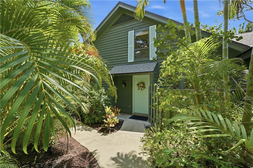 Best value in central Naples - only 2 miles from the beach. This beautifully updated, turnkey-furnished villa offers an exceptional combination of privacy, space, and location.  With 1,728 square feet of living area, the thoughtfully designed floor plan features a first-floor primary suite, versatile den, full-size laundry room, and spacious upstairs loft-style guest bedroom with private bath and large walk-in closet.  The home lives like a single-family residence while offering low-maintenance condominium living.  Freshly painted throughout, recent updates include white kitchen cabinetry, granite countertops, stainless steel appliances, updated lighting and ceiling fans. The open-concept living and dining areas are filled with natural light, flowing seamlessly to a large screened lanai with peaceful landscaped views and exceptional privacy.  Bent Pine Villas is one of Naples’ most charming garden-style communities, surrounded by rich tropical greenery, and winding walkways that create a private setting rarely found this close to the beach.  This pet-friendly community offers a relaxed lifestyle with a community pool and fishing pier overlooking the pond. HOA includes lawn care, pest control, water, sewer, and trash for true lock-and-leave convenience.  Ideally located in the heart of Naples, this hidden-gem community is just minutes to Park Shore, The Moorings, Waterside Shops, Venetian Village, and downtown Naples.  A rare opportunity to own a move-in-ready home in a prime location at this price point.