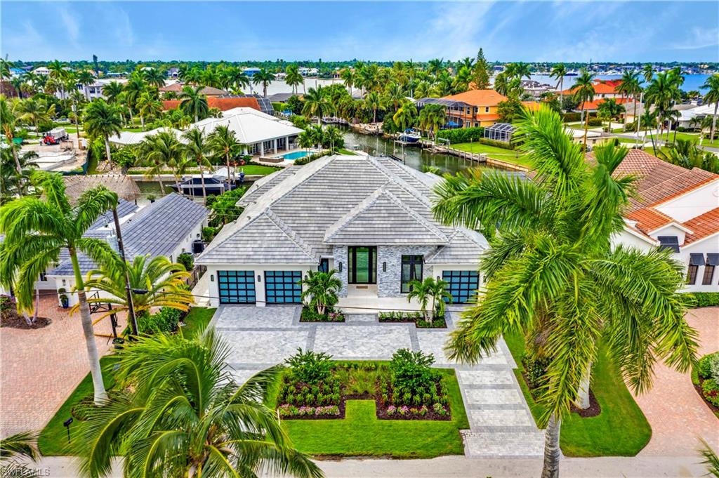 This spectacular coastal contemporary newly constructed waterfront home designed by Stofft Cooney is located on the best and deepest canal Royal Harbor has to offer, it sits on long T canal view lot allowing easy turn around with a brand new, 82 ft concrete seawall. This beautiful home has 4 suite bedrooms with 4 full bathrooms, including a casita with a separate entry that has unbeatable water views. High vaulted ceilings make this a spacious and open floor plan. All high end appliances with a large island, breakfast bar and separate wet bar. The home has 10ft wall sliders that go all the way into the wall allowing for a completely open layout between the inside and the outside living space. All windows are impact. The laundry room is very spacious with tons of storage as well. The outside entertaining space has a large pool and outside grill/counter space. The outdoor space has electrically powered screens and or storm shutters that come down when needed. This home has a 3 car garage with electric automobile charging stations as well. There is a 500 gallon propane tank buried in the front yard. You do not want miss out on this western rear view newly constructed waterfront home!