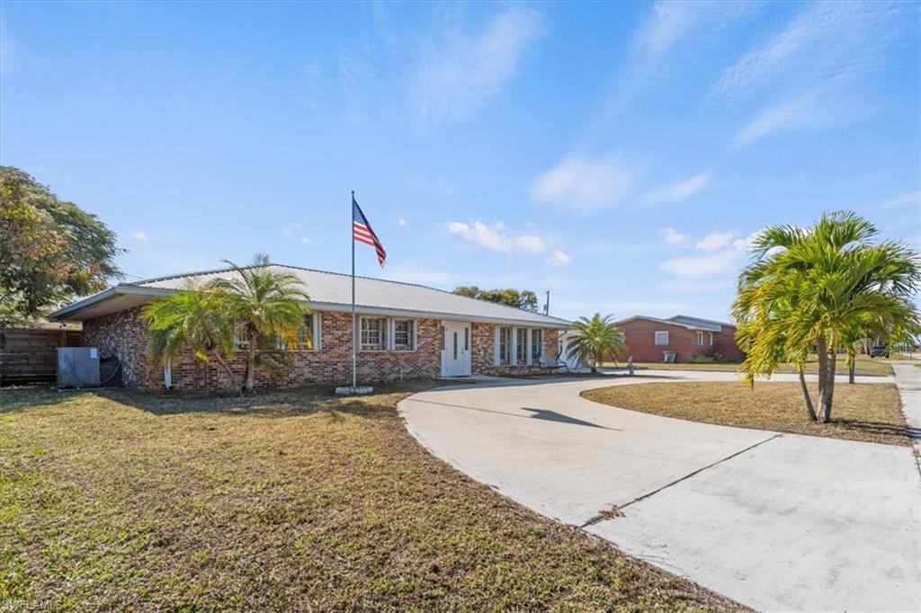 4 bedroom and 3 bathroom home with 2,396 sqft! The exterior features 100% brick faced with circle drive! A fenced back yard with two sheds, and window hurricane shutters. Spacious 2-car garage. The interior has an open concept living-dining room, florida sun room attached, kitchen with breakfast bar, granite counter tops, laundry room. The plumbing is all pvc pipe updated with water filtration system and tankless water heater. Many highlights to this home also include it's location just walking distance from Lake Okeechobee!
