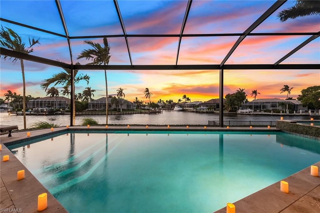 Introducing one of the most impressive homes on Marco Island, on a cul-de-sac homesite, and offering four spacious bedrooms plus study, 5.5 baths and 176 feet of waterfront with converging waterway views. Quick direct-boating access and western views with sunsets are highlights of this special home that shows like a model and offers exceptional privacy like you’re on your own private island. Dramatic entry doors reveal a grand foyer leading to the open layout that provides extraordinary natural light. Beautifully appointed with high-quality finishes, coastal décor and furnishings, soaring ceilings, crown molding, impact glass, plantation shutters, custom closets, generator, water filtration, tankless hot water heaters, and an oversized 2.5-car garage with epoxy floor. Every inch is perfection. The gourmet kitchen is equipped with a Sub-Zero refrigerator, walk-in pantry, two islands, Wolf gas range with pot filler, beverage coolers and ice maker. Generous picture-frame screened lanai with cypress ceiling, travertine, outdoor kitchen, 52-foot saltwater pool and spa with sun shelf, electric screen and outdoor shower. Private dock with 16,000-pound boatlift for vessels up to 35 feet.