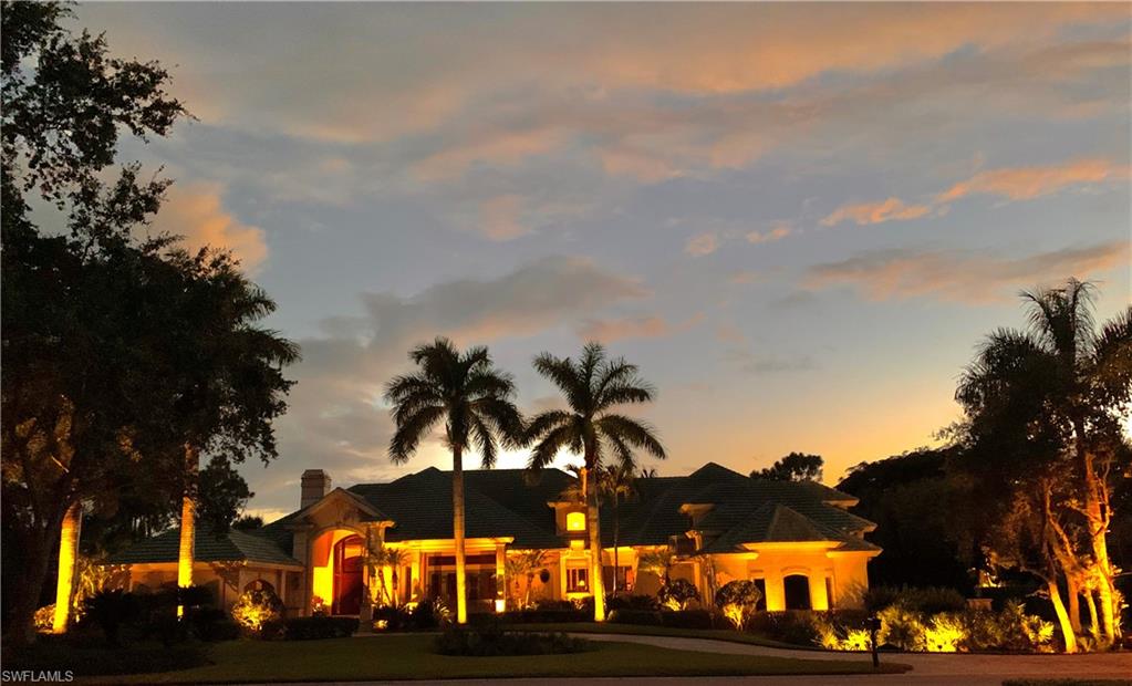 From the moment you pull into the circular driveway and park beneath the elegant Porte Cochère, you'll immediately sense that this home is truly special. The grand mahogany front doors open to reveal a stunning living room, complete with built-in bookcases, a fireplace, and soaring coffered ceilings. This inviting space flows seamlessly onto the outdoor patio, pool, and screened Lanai, where sliding glass doors pocket away to offer an unobstructed, wide-angle view over the pool, extending all the way to the tranquil lake beyond. The master bedroom is a serene retreat, featuring a cozy fireplace and a sitting area with a large picture window that frames breathtaking views of the lake and surrounding woods to the west. A sliding glass door leads out to the Lanai, blending indoor and outdoor living. The master bathroom is an oasis, with dual sinks, a jetted whirlpool tub, and an expansive shower with multiple showerheads and transom lighting overhead. A lighted makeup vanity and a coffee bar area further enhance the space, providing the ultimate in convenience and luxury. The master closet, accessible from both the bathroom and the living room, offers ample storage and organization. The formal dining room is a delightful space, with large windows and elegant transoms above, creating a bright and inviting atmosphere for dining. The heart of the home is the Great Room and Kitchen area, designed for easy flow between all parts of the house. Large pocketing sliding glass doors open wide, offering access to the sundeck, sitting area, and outdoor kitchen/eating space in two directions—perfect for entertaining and enjoying the outdoors. A guest suite hidden away on the ground floor "The Hacienda Room" offers seamless access to all parts of the home while affording perfect peace. The office features large pocket doors, allowing for privacy when needed while maintaining an open connection to the main living spaces. A beautifully crafted circular staircase leads to the upper level, where guests can enjoy privacy and tranquility in thoughtfully designed spaces. Two guest rooms upstairs provide a peaceful retreat, ensuring comfort and relaxation. The "West Indies Room" at the back of the home features French doors that open onto a balcony overlooking the pool and lake, offering stunning views and a serene atmosphere. The "Whimsy Room" above the garage is both charming and comfortable, with all the amenities one could need to feel right at home. Additional features of this exceptional property include a three-car garage and a workshop space, accessible only from the garage or the driveway. This truly is a one-of-a-kind home, offering comfort, rest, and relaxation for everyone.
