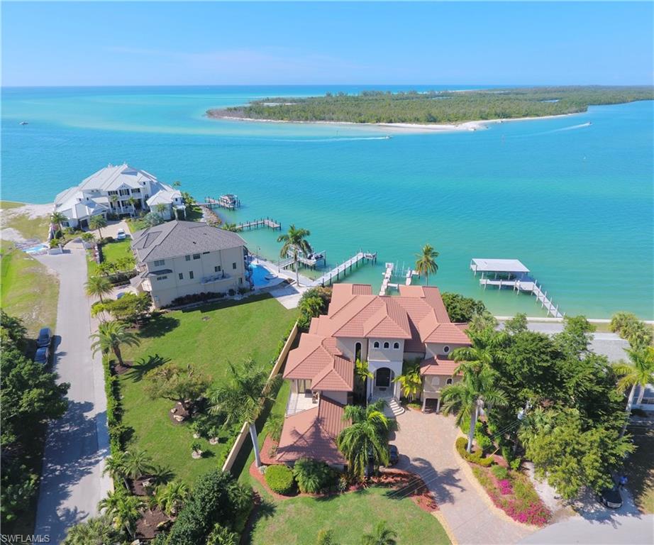 Amazing Gulf and Bay views from every room of this magnificent home. Located on the tip of the beautiful Isles Of Capri in Naples. Custom built in 2007 this home features a Spacious Floor plan, Chef's Kitchen with gas cooking, wine cooler, pantry, Granite Counter-tops, Volume Ceilings, Impact Windows and Sliders, Travertine marble floors in main living area and Brazilian Oak wood flooring in bedrooms. Custom closets, Large Balconies off every bedroom. Tons of Storage, Game room, 3 car oversize garages, Elevator for easy access to all floors, Large Heated Swimming Pool, Spa, Boat dock, 12,000 lb. Boat Lift, Panoramic Views of the Gulf of Mexico and 10,000 Islands. Enjoy Amazing Sunsets, Fantastic Fishing, Lots of wildlife and Island Living. Sit back, relax and watch the Dolphins, Manatees, sea turtles and eagles play in your back yard. Welcome to Paradise!