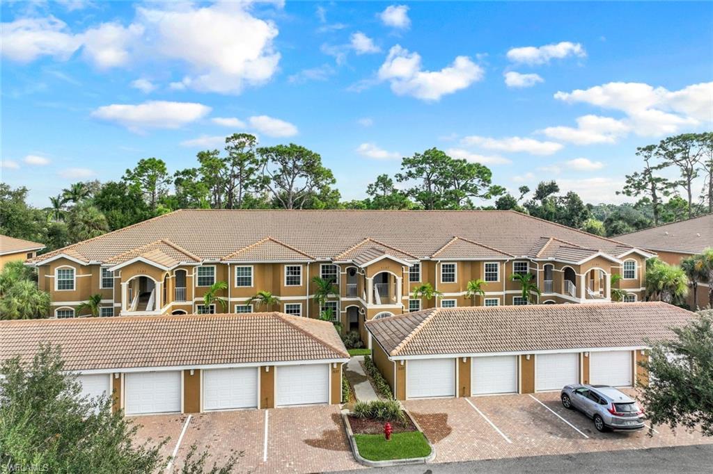 Welcome to Casa Di Fiori, a vibrant, amenity-rich gated community, where you'll find this better-than-new, first-floor end-unit condo offering 3 bedrooms, 2 baths, and a 1-car garage just steps from your front door. Ideally situated near the community's front entrance, you'll enjoy quick access in and out, along with the convenience of a LeeTran public transit stop located just outside the gate. Casa Di Fiori's prime location along Pine Island Road also places you minutes from shopping, dining, medical facilities (including the nearby VA hospital), and entertainment.

Step inside to discover a light-filled, modern home featuring 9-foot ceilings, crown molding, and tile flooring throughout the main living areas. Impact-resistant windows and custom window treatments provide both peace of mind and style. The open-concept kitchen flows seamlessly into the living space and features shaker-style cabinetry, sleek white quartz countertops, stainless steel appliances, a breakfast bar, and a separate dining area that's perfect for entertaining.

The spacious screened lanai, accessible from both the living room and the primary bedroom, overlooks a peaceful wooded area, offering exceptional privacy and tranquility. It's also pre-plumbed for an outdoor kitchen, making it ideal for enjoying Southwest Florida's outdoor lifestyle.

The primary suite features an ensuite bath with dual vanities, a custom-tiled walk-in shower, and a generous walk-in closet. A split-bedroom floor plan provides privacy for family and guests, while the second and third bedrooms share a well-appointed guest bath. A convenient in-unit laundry room adds everyday functionality.

Residents enjoy an impressive collection of resort-style amenities, including a clubhouse, fitness center, tennis and pickleball courts, and a beautiful swimming pool with hot tub. Built in 2022, this move-in-ready condo also offers the added benefit of no required flood insurance. Whether you're searching for a full-time residence, seasonal retreat, or investment opportunity, this exceptional condo offers the perfect combination of modern finishes, low-maintenance living, outstanding amenities, and an unbeatable location.