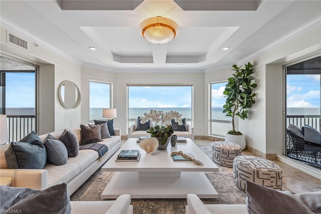 Gorgeous gulf and beach views! High floor gulf view residence directly on the beach in the private gated community of Bay Colony. Featuring panoramic views of the Gulf of Mexico through hurricane-impact glass picture windows and floor-to-ceiling glass sliders off the breakfast area and the primary bedroom. This highly sought-after design welcomes you into an elegant entry foyer and spacious living area boasting tile and wood floors, elegant moldings, lighting and trim and a separate dining area. The open kitchen and den area offer plenty of room for entertaining family and guests including two full guest bedrooms, both with en suite baths. Extra storage at garage level. The Biltmore amenities include an impeccably renovated lobby with 24-hour staffed front desk, two guest suites, fitness center, social rooms and a resort-style pool. Bay Colony residents enjoy the use of their own private beach club and restaurant, a tennis club, as well as use of the amenities of Pelican Bay.
