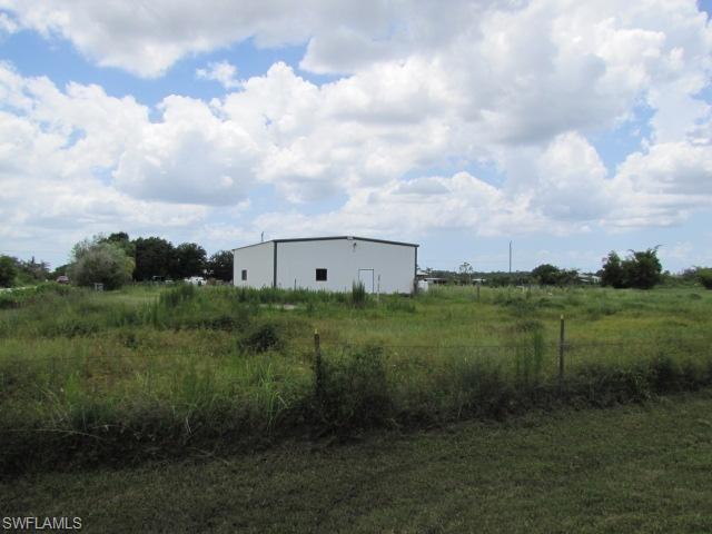 Beautiful cleared 5 acre lot just south of Pine Island Road, this parcel is one of the last large pieces of land in Cape Coral. Doesn't hesitate or you will miss it. Priced to sell fast. Building on property can be used for a variety of things. 40x50 with 2 sections inside and a bathroom. Electric and water available.