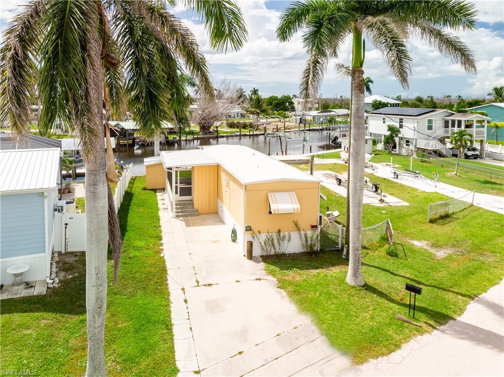 POSSIBLE SELLER FINANCING: BRING ALL OFFERS. MOTIVATED SELLER. PROPERTY IS BIENG SOLD DUE TO HEALTH REASONS. Charming 2-bedroom, 1-bathroom home at 3851 Coconut Dr, St. James City, FL, is a waterfront paradise! Nestled on a desirable wide sailboat access canal, enjoy direct Gulf access with no bridges, perfect for maritime enthusiasts. The home features granite countertops, newer refrigerator, and A/C split units. Relax on the porch with stunning sunset and water views. The partially fenced yard offers privacy, and with no HOA, enjoy flexibility. Located minutes from the Intracoastal Waterway, explore nearby islands like Sanibel, Cayo Costa, and Captiva. A golf cart-friendly community with great nearby restaurants and marinas. Ideal for year-round living, seasonal retreat, or investment!