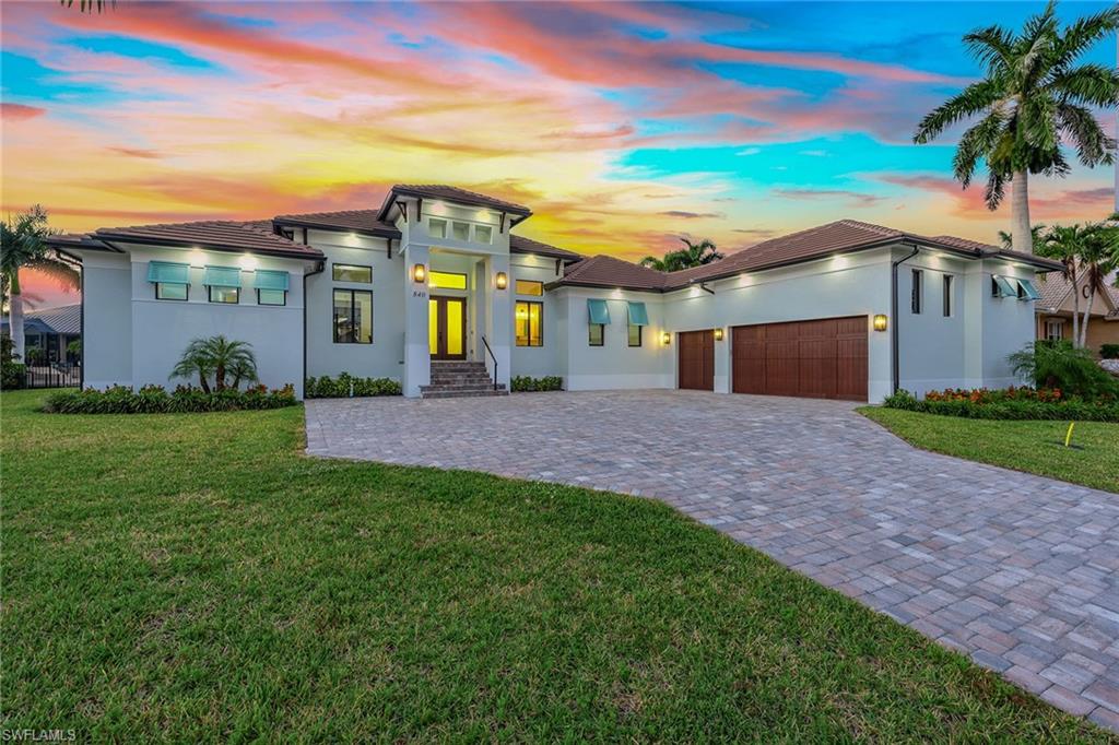 Experience unparalleled coastal luxury in this stunning 2025-completed residence offering quick, direct Gulf access and exceptional modern craftsmanship throughout. Ideally designed for refined living and effortless entertaining, this four-bedroom plus den, five-bath home sits in the desired mini-estate section on an oversized lot with a new 125-foot seawall, capturing stunning western sunsets and beautiful water views. A wide brick paver driveway sets a grand approach, leading to an inviting interior filled with natural light, volume ceilings, elegant crown molding and contemporary custom lighting. Wood floors throughout the living areas enhance the home’s warm, modern aesthetic. The gourmet kitchen is an impressive focal point, featuring striking quartzite countertops and full-height backsplash, a large island with a breakfast bar and premium Wolf appliances including a gas cooktop with hood, a built-in wall oven, a steam oven and Sub-Zero refrigerator. An adjacent dining area with large windows frames serene waterfront views, while a nearby wet bar with quartzite counter and a large Sub-Zero wine refrigerator enhances the home’s effortless flow. The living room is equally impressive, offering a custom wood-accent entertainment center with a built-in fireplace, tray ceiling, and expansive pocketing sliders that open to the lanai for seamless indoor-outdoor living. The owner’s suite is a luxurious retreat with lanai access, transom windows and two walk-in closets with custom built-ins. Its spa-inspired bath features polished porcelain tile on the floors and walls, dual quartzite vanities with a full-width LED mirror, a soaking tub, and a spectacular floor-to-ceiling tiled walk-in shower with three large privacy windows, frameless glass and multiple shower heads. Three additional guest suites each include walk-in showers, with one serving as the convenient pool bath. A double-door den provides an ideal office or study and is positioned near a full bath with a walk-in shower. The outdoor living space is exceptional, highlighted by a tongue-and-groove wood ceiling modern fans, a built-in entertainment center, and a travertine deck that wraps around the stunning pool with a sun shelf and spa enclosed by a frameless glass fence. The outdoor kitchen is ideally appointed with a barbecue, hood, refrigerator, ice machine, sink, and a natural quartzite countertop with full-height backsplash and bar counter. Impact windows and doors enhance peace of mind. Additional features include a well-equipped laundry room with porcelain tile flooring, new GE UltraFresh washer, new GE Smart front-load dryer, a utility sink and overhead cabinetry, along with epoxy flooring in the attached garage for a clean, polished finish. Ideally close to shopping, dining and all of Marco Island’s top attractions, this home also offers quick access to Veterans Park, Mackle Park and pristine shores of Residents’ Beach, and nearby executive airport.
