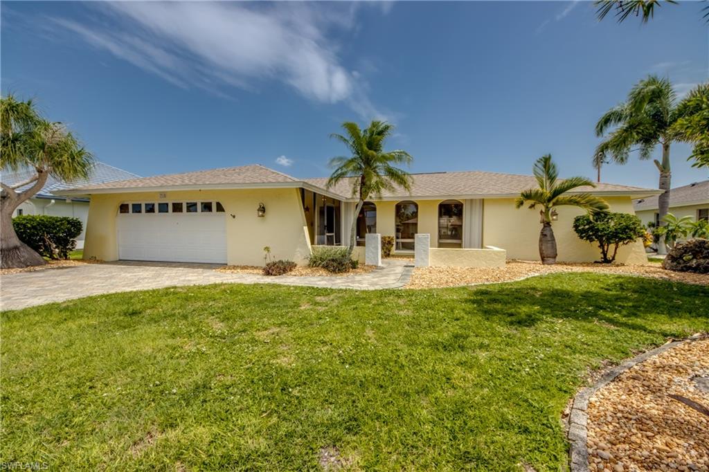 Discover the best of Southwest Florida Gulf-access waterfront living in this turnkey home, ideally located in one of Southeast Cape Coral's most established neighborhoods. Complete with a private pool, convenient pool bath, beautiful canal views, and the added benefit of being located outside a flood zone, this home offers the perfect blend of comfort, convenience, and outdoor living. Being sold turnkey, the home includes furniture, dishes, cookware, linens, and much more—making it easy to start enjoying your Florida home from day one.
The spacious split-bedroom floor plan features, cathedral ceiling with recessed lighting in the formal living and dining room, a vaulted ceiling with recessed lighting in the family room, a cozy wood-burning fireplace, and relaxing waterfront views from the primary bedroom, kitchen, family room, dining room, and rear guest bedroom.
The kitchen is designed for both everyday living and entertaining, featuring wood cabinetry, stone countertops, under-cabinet lighting, pendant lighting over the breakfast bar, a convenient pass-through window to the lanai, with a wet bar. Step outside to the large screened lanai with an expansive under-truss entertaining area overlooking the pool and canal. Whether you're enjoying your morning coffee or gathering with family and friends, this outdoor space is sure to become a favorite. The waterfront features a concrete dock, a brand-new wooden deck dock with a captain's walk, and an existing boat lift, offering Gulf access right from your backyard.
Additional features include tile flooring throughout, accordion hurricane shutters, and a location just minutes from shopping, dining, parks, and the bridges to Fort Myers. Whether you're looking for a year-round residence, seasonal retreat, or investment property, this home offers everything you need to start enjoying the relaxed Southwest Florida waterfront lifestyle.