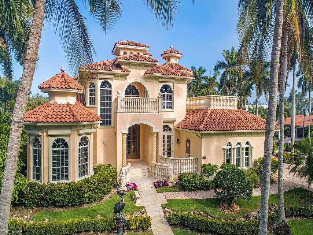 H.14126 -Located just steps away from the magnificent white sandy beaches and the blue waters of the Gulf of Mexico. This stunning home sits on an elevated corner lot only 1/2  block to the beach and 2 blocks to iconic 3rd street south. Enter the gorgeous arched mahogany/glass front doors to a perfectly appointed oasis. Freshly painted throughout, marble floor coverings, new carpet, fixtures, 2 gas fireplaces & open balconies are just a few of the beautiful features. The spacious master suite boast an amazing walk in closet & private covered screened balcony. A secluded study w/ covered terrace and sunset room with a morning kitchen & over-sized balcony are the perfect places to relax.  Soak in the spa, swim in the salt water pool, grill on the expansive covered screened lanai. The spacious fenced side yard and three car garage makes this home truly the ultimate in easy living. ** Flood insurance policy is transferable to the new buyer, policy is only $1,300.00 annually.