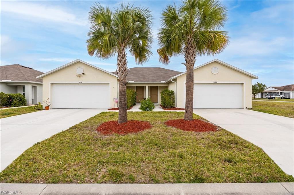 Welcome home to this beautifully updated 2-bedroom, 2-bath twin villa located in the gated community of Vistanna Villas. With 1,120 square feet of living space, this move-in-ready home features peaceful lake views. Inside, you'll find almost new luxury waterproof vinyl plank flooring, carpet in bedrooms, updated lighting, ceiling fans, and a bright, open living area designed for comfortable everyday living. The well-appointed kitchen features a French-door refrigerator with bottom freezer, built-in ice and water dispenser, and convenient pull-out cabinet shelving for added storage and organization. The spacious primary suite includes a beautifully updated walk-in shower, while the interior laundry room comes complete with a washer and dryer for added convenience. The attached garage offers additional storage space and is equipped with a dedicated electric vehicle charging outlet. Enjoy a true low-maintenance lifestyle with lawn care and exterior maintenance included. Residents of Vistanna Villas also have access to the community pool and enjoy a convenient location just minutes from shopping, dining, medical facilities, Southwest Florida International Airport, I-75, and the area's beautiful Gulf Coast beaches. If you're looking for a clean, updated, low-maintenance home in a desirable gated community, this exceptional villa is ready to welcome you home.