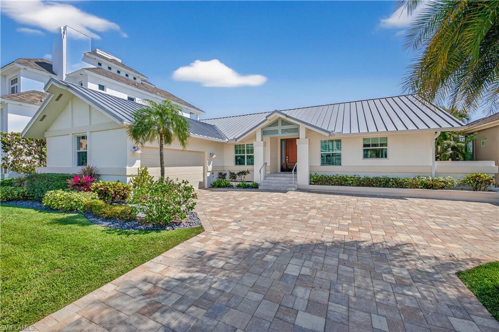 Nestled in the coveted Connors/Vanderbilt Beach neighborhood, this beautifully renovated four-bedroom waterfront retreat offers the rare combination of beachside serenity and boating freedom all on one level. The southern exposure fills the property with natural light and inside you’ll find light coastal finishes, an open-concept great room, custom cabinetry, and tasteful turnkey furnishings creating a space that is polished and move-in ready. The home is situated just steps away from a dedicated Vanderbilt Beach access walkway and for boaters there is direct Gulf access. The outdoor living experience continues, with a screened outdoor patio with room to add a pool. Built with concrete block construction, a standing seam metal roof, and impact glass throughout, the home is situated high and dry giving buyers peace of mind that is hard to find in coastal Naples. This fully renovated home represents an exceptional opportunity to own one of Vanderbilt Beach's finest addresses without the wait, the risk, or the complexity of a build.