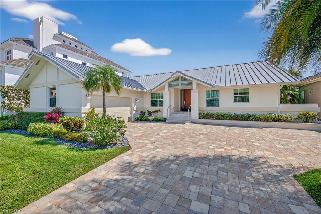 Nestled in the coveted Connors/Vanderbilt Beach neighborhood, this beautifully renovated four-bedroom waterfront retreat offers the rare combination of beachside serenity and boating freedom all on one level. The southern exposure fills the property with natural light and inside you’ll find light coastal finishes, an open-concept great room, custom cabinetry, and tasteful turnkey furnishings creating a space that is polished and move-in ready. The home is situated just steps away from a dedicated Vanderbilt Beach access walkway and for boaters there is direct Gulf access. The outdoor living experience continues, with a screened outdoor patio with room to add a pool. Built with concrete block construction, a standing seam metal roof, and impact glass throughout, the home is situated high and dry giving buyers peace of mind that is hard to find in coastal Naples. This fully renovated home represents an exceptional opportunity to own one of Vanderbilt Beach's finest addresses without the wait, the risk, or the complexity of a build.