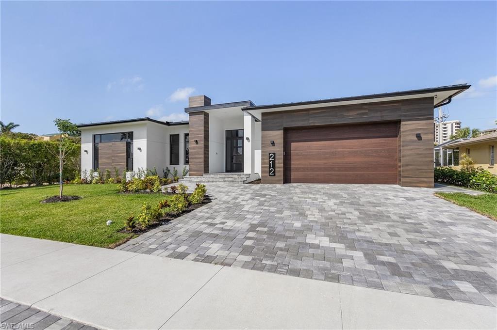 This recently built contemporary gem is available for purchase and is situated just a few blocks (just a short jaunt) away from the public beach access. No detail has been overlooked in the creation of this exceptional home. The property is being sold turnkey furnished and boasts four bedrooms, three full bathrooms, and an oversized two-car garage. The outdoor area is a true oasis, complete with a breathtaking pool, an abundance of covered space featuring an outdoor kitchen, and ample deck space for relaxation. This home has been upgraded to the highest standard, including custom lighting, accent walls, elegant tile flooring throughout, expansive sliding glass doors, built-in speakers, and sophisticated decor. The rental income for this home can easily reach approximately $160,000, as the "twin" of this home in Marco Island has a strong rental history. This home is perfect for either personal use, as a lucrative investment opportunity, or both!