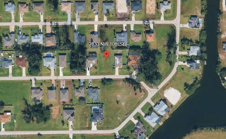 Seller financing available: 25% down, 10% interest, 3-year term with balloon payment; buyer responsible for taxes, closing costs, and maintenance. Great opportunity to build your future home on this standard-sized vacant lot located in the expanding and highly desirable Northwest Cape Coral area. Featuring northern rear exposure, this property offers cooler afternoon shade in the backyard, ideal for comfortable outdoor living and energy efficiency. This lot is positioned within North 7 of the Utilities Expansion Project, with city water and sewer installation planned (dates TBD), adding long-term value and appeal for both homeowners and investors. Surrounded by new construction and conveniently located near parks, schools, shopping, and major roadways, this homesite provides excellent potential in a growing community. Whether you are ready to build or looking for a solid investment, this lot presents an attractive option in one of Cape Coral’s fastest-growing neighborhoods.