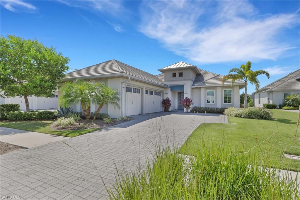 Nestled within the gated Isles of Collier Preserve, this beautifully appointed 5-bedroom, 3.5-bath contemporary home with a 3 car garage sits on a large lake lot with coveted southern exposure in one of the most desirable positions in the community. Built on the Easton 3 model, the only stock floor plan that maximizes square footage on the lot, every inch of this home has been thoughtfully utilized. Double tray ceilings with custom lighting elevate the master suite, great room, and the versatile 5th bedroom can be used as a den or flex space if you don't need the 5th sleeping space.
Designed with entertaining in mind, the chef's kitchen with gas cooktop (500 gallon tank), Sonos sound system, and seamless indoor-outdoor flow set the stage for effortless living. The expansive lanai with an oversized pool and spa with panoramic screen cage is an entertainer's dream, featuring a resort-caliber outdoor kitchen complete with a dishwasher, sink, refrigerator, and built-in drawers — all framed by stunning, unobstructed lake views. Located on Rodney Bay, a quiet cul-de-sac enclave tucked away from the main thoroughfare, this home offers a true sense of community with friendly neighbors and peaceful surroundings. The primary suite has amazing space with dual vanities, custom built closet systems, and a large shower and tub.
The Isles of Collier Preserve spans more than 2,400 acres, with nearly half dedicated to natural habitats. Residents enjoy world-class amenities at the Isles Club, including a resort-style pool, lap pool, fitness center, 14 pickleball courts, 6 tennis courts, bocce, a dog park, kayaks, paddleboards, sauna, yoga, and the waterfront Overlook Bar & Grill. Less than 5 miles from downtown 5th Avenue, pristine beaches, world-class dining, boutique shopping, Hamilton Harbor Yacht Club, and the Naples Botanical Gardens — this is one of the premier addresses in all of Naples.
