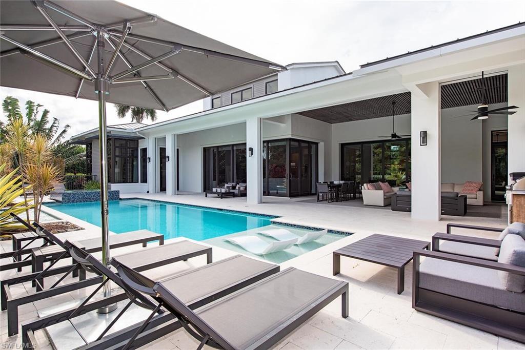 Located on a huge corner lot, this custom home designed by architect Jonathan Kukk, is a short walk to the Gulf of Mexico and Naples' famous white sand beaches. Exquisite interior finishes by Design West and furnishing/design package by Robert Brown of Atlanta give a modern coastal feel. Built by Gulfstream homes, this one of a kind residence features 6,651 sq ft of luxurious living space that flows seamlessly to the outdoor living area. Soaring 21 foot ceilings showcase stained white oak accents and LED back lighting can be found throughout the home. Residence is outfitted with Control 4 home automation with security cameras, a full electronics & audio package, and a whole house generator.  Ruffino Cabinetry, Legno Bastone white oak floors and large Andersen windows providing an abundance of natural light can be found throughout the home. Exquisite interior features merge into a tropical oasis through pocketing sliders where one will find shell stone decking, roll down screens and gorgeous extensive Landscaping by Architectural Land Design.  Ideally located near the new Four Seasons Resort and just minutes to downtown Naples fine dining, world class shopping and entertainment.