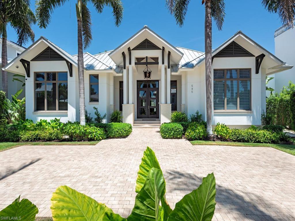 Discover an exquisite retreat in the heart of Olde Naples, just 2.5 blocks from 3rd Street South, featuring some of Naples’ most desirable shopping and dining experiences. Enjoy the sugar-white sands of the Gulf just moments away. This impeccably designed residence embodies refined coastal elegance, offering four lavish bedroom suites—each with a private ensuite bath and spacious walk-in closet—alongside a private study, stylish powder room and dedicated pool bath.
Every detail has been thoughtfully curated, from the oversized four-car garage to the seamless indoor-outdoor living experience. An expansive covered lanai, complete with a fully appointed outdoor kitchen, frames the sparkling pool and creates a captivating setting for sunset dinners and sophisticated entertaining. A rare blend of luxury, comfort, and prime location—this is Naples living at its finest.