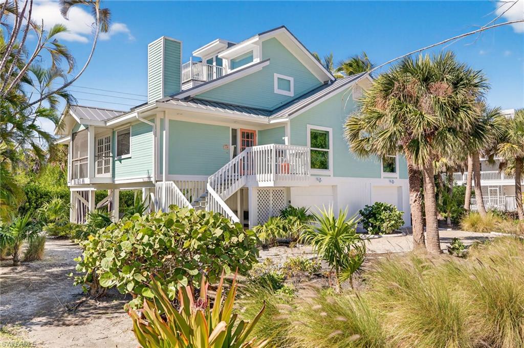Perfect Island Beach House!!! The Gulf is directly at the end of the quaint shell Southwinds Drive. Sanibel's incredible shelling and miles of walkable beaches are a just steps away! Elevated, updated, and whimsically decorated, this home is ready to enjoy. High ceilings and walls lined with windows greet you at the front door. The living area flows beautifully and provides plenty of distinct spaces for relaxing and entertaining. The primary suite and two additional en suite bedrooms are on the main living level as is an additional 1/2 bath. The top floor has great space for living and sleeping spaces and includes a small spiral staircase that leads to a rooftop porch with fantastic view. The incredibly weather resilient aluminum standing seam roof was installed in 2021. Enclosed garage and lower level storage space with an interior staircase provide great convenience. The remainder of the lower level creates fantastic covered outdoor living space that is open to the thoughtfully landscaped private yard. With tremendous natural light, high ceilings, space for guests and the beach at the end of the street, this is your perfect island home!