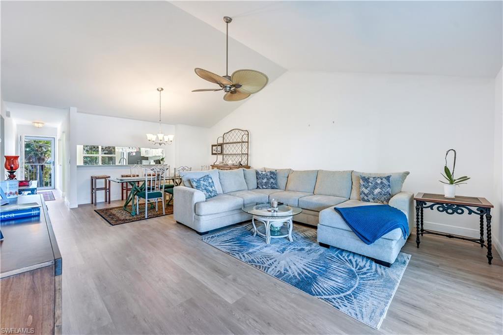 RARELY AVAILABLE EXTRA WIDE TOP FLOOR UNIT. Located in the beautiful Naples Sandpiper Bay Club Community, is this well maintained and move-in ready condominium. This top floor, EXTRA WIDE unit, with impact storm windows, has two bedrooms; two bathrooms and larger lanai, which is glass enclosed. The great room has vaulted ceilings and has extra large living space, approx 17' x 26'. The kitchen features some stainless steel appliances, upgraded cabinets, Corian countertops and reach-in pantry. The primary bathroom has a glass-door enclosed shower, separate vanity area, & walk-in California closet. The guest bedroom has a reach-in closet. The guest bathroom has updated vanity & shower/tub combo. There is extra storage in the Laundry room, equipped with cabinets and a countertop for your convenience. Enjoy the serene setting, all year long, from your glass enclosed; screened lanai. LVT flooring throughout. All of the windows have plantation shutters. The lanai has a tile floor. This  community offers 2 (heated) pools, clubhouse, BBQ areas, private community boat docks that periodically become available for purchase. Gulf access; no bridges. There is 1 assigned parking space & available guest parking.