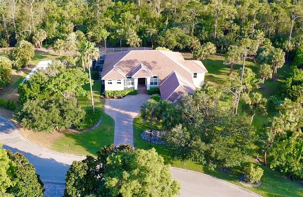 Welcome home to this private oasis on over an acre of land in the highly sought-after gated community of Devonwood Estates. Completely renovated over the last 2 years, this home is upgraded with all the high-end modern details you desire and is move-in ready. Nestled at the end of a cul-de-sac, the shape and size of this lot give complete privacy to the pool and screened-in lanai while backing up to miles of Estero preserve that will remain undeveloped for your seclusion. Zero/corner-door sliders pocket open to let the peace of nature and light fill the great room and kitchen to maximize the indoor-outdoor living that Florida offers. The chef's kitchen features natural exotic stone countertops, a gas range, a hidden coffee bar and an exceptionally large walk-in pantry. Adjacent is the custom temperature-controlled wine room with a floor-to-ceiling glass display. The yard features a private volleyball court and fruit trees for your enjoyment as well. This affordable price point within the gates is a rarity you will want to act quickly. Call to set up your private showing.