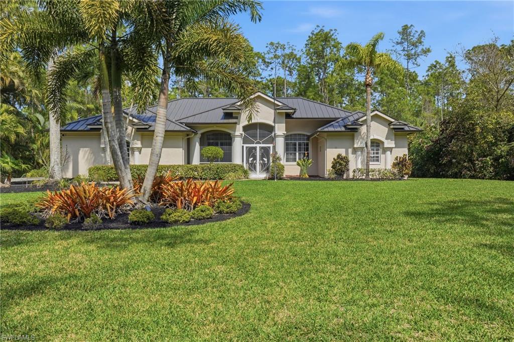 Welcome to Collier Woods where space, privacy, and natural beauty come together on 2.5 acres with no HOA restrictions.

Built by the original owners, this one-owner home has been meticulously cared for over the years and offers a strong foundation with major updates already in place. Recent improvements include a durable metal roof, panoramic screen cage, newer A/C system, new water heater, hurricane impact sliding glass doors, and hurricane-impact garage door — providing peace of mind for years to come. While the home presents an opportunity to update to your personal style, the most important investments have already been made.

A long driveway and mature landscaping create a welcoming first impression. Inside, the home features 3 bedrooms, 2 bathrooms, formal living and dining rooms, and a spacious open-concept kitchen and family room designed for everyday living and entertaining.

The kitchen offers a large center island, pantry, and breakfast nook overlooking the expansive backyard — where deer are known to stop by during quiet mornings. The laundry room is conveniently located just off the kitchen and includes cabinetry, a utility sink, an additional storage closet, and direct access to the two-car garage.

The primary suite offers direct lanai access through impact sliding glass doors, two generous walk-in closets, and an ensuite bath featuring dual vanities, a soaking tub, walk-in shower, and separate water closet. The split-bedroom layout places the two guest bedrooms and full bath in a private wing off the family room — ideal for family or visiting guests. The guest bath also serves as a pool bath, providing convenient access to the outdoor living space.

Outdoor living is truly special here. The expansive screened lanai features a panoramic cage, heated pool and spa, slip resistant Soft Crete pool deck, and a generous covered seating area for entertaining. A hookup is already in place for a future outdoor kitchen, allowing you to further customize the space to your lifestyle. Surrounded by mature trees and open space, the property offers exceptional privacy while still being close to everything.

Located in a top-rated school zone, just 5 minutes from shopping and dining options, and approximately 20 minutes to Naples’ beautiful white sand beaches, this property offers the rare combination of acreage living with everyday convenience.

If you’ve been searching for space, privacy, and the freedom of no HOA in North Naples, this Collier Woods property is an exceptional opportunity.