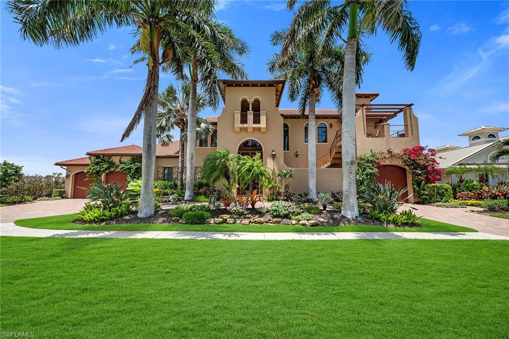 Enjoy sweeping bay views and direct Gulf access from this exceptional custom-built waterfront residence, thoughtfully designed with high-end finishes and craftsmanship throughout. Perfectly positioned to capture stunning water vistas and offering approximately 131 feet of waterfrontage, this home embraces the best of Marco Island living. This spacious home offers four bedrooms plus a den, four full baths, and two half baths, along with expansive indoor and outdoor living spaces ideal for everyday comfort and entertaining. Boating enthusiasts will appreciate the private dock with lift, providing quick, direct access to the Gulf for endless days on the water. A grand entry welcomes you into an elegant interior featuring tile flooring, tray ceilings, abundant storage throughout and a private elevator providing convenient access to multiple levels. The open-concept living areas are filled with natural light and seamlessly connect to the outdoors through walls of glass sliding doors that open to the expansive screened lanai. The inviting living room showcases beautiful water views, tile flooring, ceiling fans and effortless access to the outdoor living areas. Designed for entertaining, the kitchen is appointed with rich wood cabinetry, granite countertops, travertine flooring, a center island with seating, and a full suite of appliances including a dishwasher, microwave, Sub-Zero refrigerator with icemaker, wall oven and a Wolf induction cooktop. Adjacent dining spaces create an ideal setting for casual meals or formal gatherings, while a stylish wet bar featuring counter seating and a wine cooler enhances the home's entertaining appeal. The first-floor primary suite serves as a private retreat, offering tranquil canal views, abundant natural light, tray ceilings, ceiling fan, and direct access to the screened lanai through glass sliders. Dual custom walk-in closets provide exceptional storage, while the luxurious bath features dual vanities, a separate soaking tub, an oversized shower with multiple shower heads and an enclosed water closet. Upstairs, a spacious loft television room creates an additional gathering space complete with a wet bar and dedicated area for card or chess games. Three generously sized guest suites each feature private en-suite baths with glass walk-in showers, ceiling fans, and access to private balconies, ensuring comfort and privacy for family and guests alike. Outdoor living is elevated by an expansive screened lanai featuring an electric heated pool with integrated spa, a fully equipped outdoor kitchen, multiple balconies and spectacular bay views that create a resort-inspired setting. Additional conveniences include a laundry room equipped with Whirlpool washer and dryer, utility sink and ample workspace. Offering an extraordinary blend of luxury, comfort and premier boating access, this waterfront residence delivers the ultimate Marco Island lifestyle.