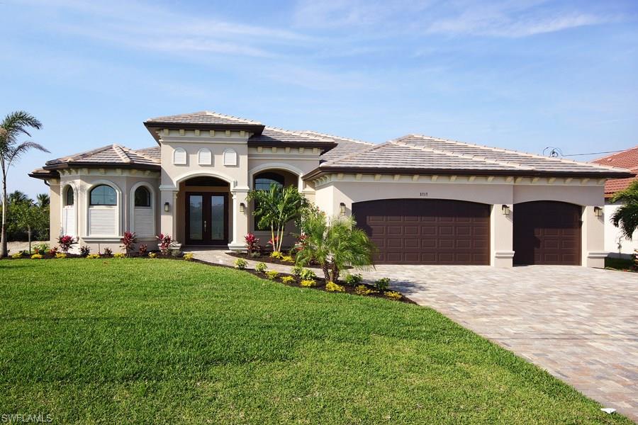 The Cayo Costa model will feature square windows & front & rear columns for those who prefer a more contemporary look. Kitchen will feature a large center island with sleek modern finishes. The builder strives to marry today's look with the detail, quality and livability of a traditional luxury home. Quality of home is clear in architectural stone trim, hurricane impact including rainfall glass entry doors, 9’ high  disappearing sliding glass doors open to spacious under truss lanai featuring summer kitchen. Master bedroom overlooks lanai & spa. Master closets fitted with custom cabinetry. Master bath has his n her vanities w/oversize mirrors & soaker tub. Walk-through shower has rainfall head, polished marble walls & riverstone floor. Your custom pool & spa feature two-tone pebble tech finish, glass tile & decorative mosaics. High-end lighted tray ceilings, granite, Delta fixtures, whole-house R/O sys, high efficiency 14-seer A/C, low maintenance landscaping, decorative epoxy-painted garage floor complete your dream home. Water & well equip under truss for longevity & security, A/C handler inside for energy efficiency. 125’ canal. Photos of model.