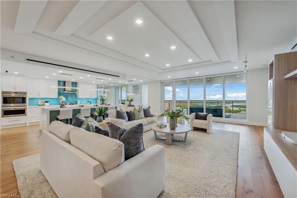 This contemporary and desirable '03 unit on the 16th floor of Kalea Bay's T100 is now available! A modern open floor plan exudes luxury and sophistication while the expansive floor-to-ceiling windows frame breathtaking views of the Gulf and Wiggins Pass. The interior features a sleek upgraded finishes, including wood flooring, designer lighting and ceiling details. A chef's kitchen features quartz countertops, Wolf® and Subzero® appliances, and large island that adds to the elegance. The living area is spacious and designed for seamless indoor-outdoor living, leading to a large lanai and panoramic view, perfect for enjoying the stunning sunsets over the water. State-of-the-art smart home-ready technology is added for convenience. The Owner’s suite, offering spectacular water views, a spa-like bathroom & large walk-in closet, is a personal retreat. Guest bathrooms are outfitted with upgraded floating vanities with under-lighting. Amenities within the community rival a five-star resort, including a resort-style pool, new Wellness Center, racquet sports, three pools and two restaurants. An unparalleled lifestyle of luxury and comfort, making it an ideal choice for discerning buyers.