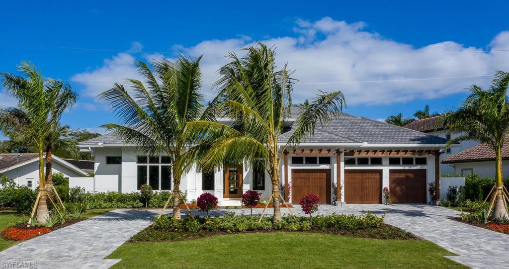 Located one of the most beautiful streets in the Moorings, this single-story, newly constructed residence backs up to the Moorings Country Club. Designed by renowned architect Falconer Jones, the spectacular light-filled, five-bedroom home with volume ceilings flows gracefully from one engaging space to another. The Kitchen is complete with island seating, plenty of counter space, top-of-the-line appliances, and a glass-enclosed walk-in wine room with separate refrigeration. A great room floor plan with a full wall of glass french doors leads out to a spacious covered lanai, outdoor kitchen, fireplace, and pool area. Interior living spaces blend harmoniously with outdoor living areas. The master retreat, with private sitting area, offers a spa-like amenities including an aromatic cedar dry sauna, custom shower, soaking tub, dual vanities and his/hers water closets. Spectacularly sized walk-in closet and dramatic views complete this secluded retreat. Four additional en-suite bedrooms provide comfortable and private space for family and friends. A tropical setting with long views, this home is eligible for the Moorings private beach access.
