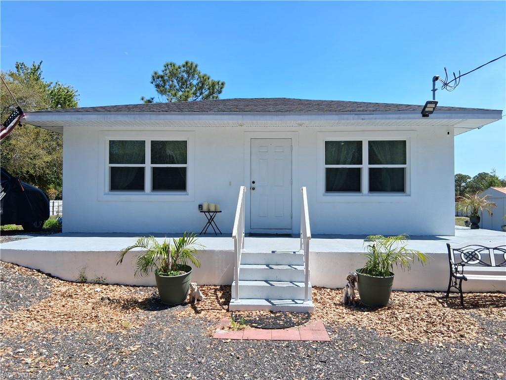 New Construction this is a beautiful 2024 block 2-bedroom 1-bathroom 826 sq ft home on 1.09 acres fenced in with a privacy fence. Wide hallways and shower great for wheelchair accessibility. Tile floors and spacious rooms. Recessed lighting throughout the house. Built up on a solid foundation that could support a second story or additions. Open porch on the rear with closet space for storage and enjoying the outside view. Septic tank big enough to support an additional room and bathroom if wanting to expand. On Well with indoor filters and water softener. Additional tanks of water powered by generator ready to bring water in case of power failure. Hurricane Impact Resistant Windows. Two sheds for storage stay with the property. Shed with water softener has electric inside. Property comes furnished. Fenced in area for chickens and chicken coop. Chicken lay eggs daily and will stay. Milling has been added for a smoother parking area in the front of the home as well as standing trees great for shade. Fruit trees planted. This community offers residents at no charge a Community Pool-house and Clubhouse. NO HOA, rural golf-cart and horse-friendly community. 1.5 hr from each coast. Community is growing and has convenience and small grocery stores. 25 min from downtown Clewiston. Pay no city taxes. Enjoy the warm Florida weather year-round. Property qualifies for VA, FHA and USDA lending. Call to schedule your private showing today!