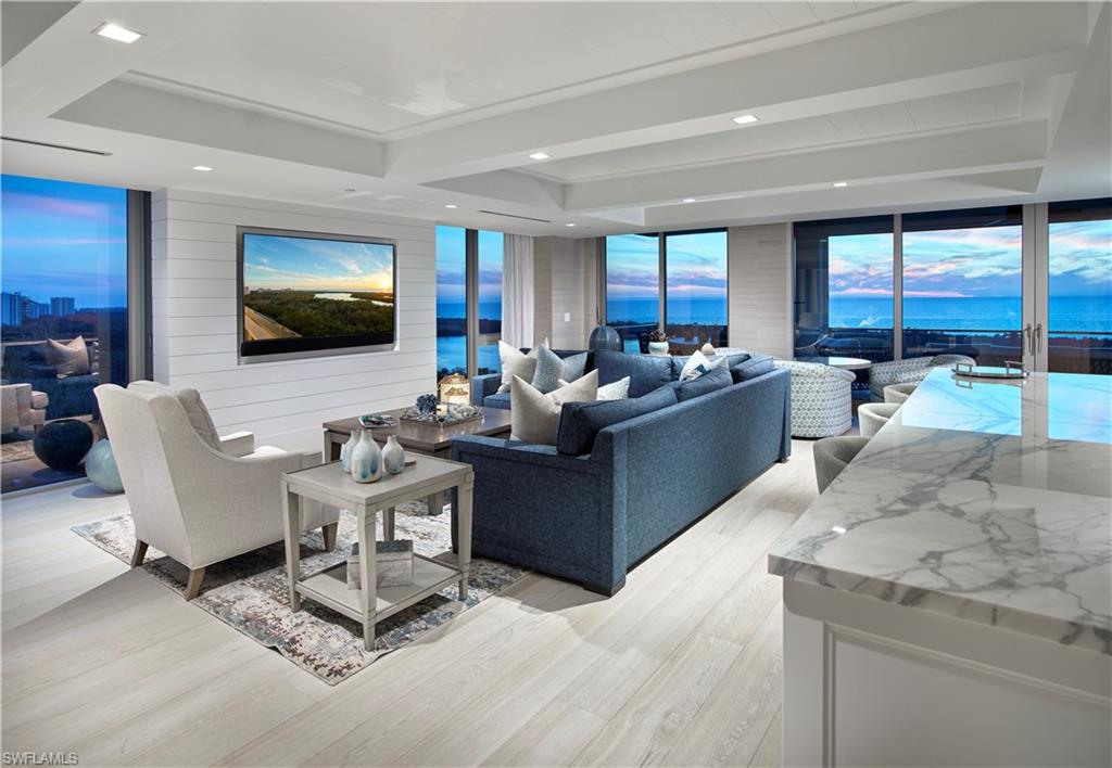 Balancing modern lines and a coastal design, this turnkey 12th floor home in the sky is a dream.  Stunning southern vistas of the shimmering coastline, gulf and beyond are the focal point from the floor to ceiling window walls. Chic ship lap walls, transitional ceiling details, elegant lighting and quality finishes throughout are sure to impress.  Entertaining is a breeze in the spacious kitchen which easily flows to the open air, glass rail lanai to take in the best of views while also featuring a convenient bar island with dual wine coolers. The master bedroom is paradise found and offers an amazing closet, freestanding bath and luxurious shower, all with a view of the serene preserve to help unwind and relax.  Smart home integrated with Savant and Lutron, there is nothing this custom built out unit left out and is perfectly positioned in the highly sought-after Mystique high rise.