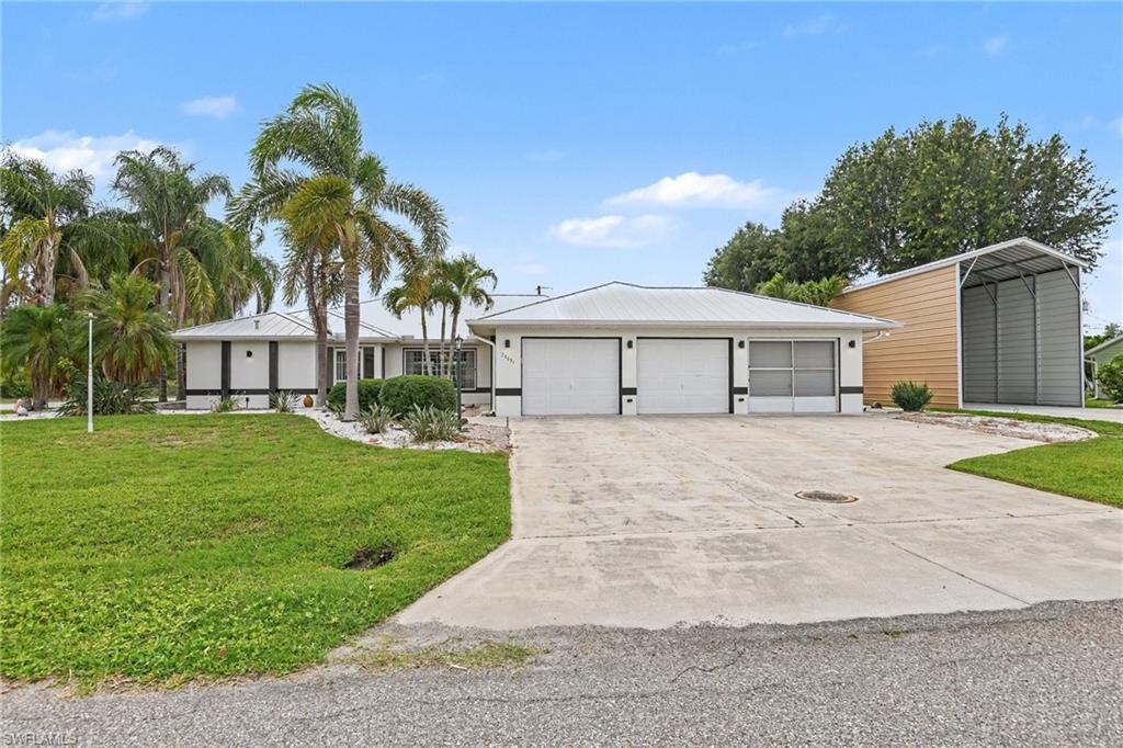 Just what you would expect from the Florida lifestyle! Situated on an oversized corner lot, this magnificent pool home offers the perfect combination of comfort, functionality, and resort-style living. From the moment you arrive, you'll appreciate the attractive curb appeal, freshly painted exterior, durable metal roof, and inviting screened porch. The oversized 3-car garage includes a screened garage door on one bay and utility sink. The Carport offers even more covered space for recreational vehicles, boats, trailers, or toys, with the potential to be enclosed and a garage door also added.  Step inside through elegant French doors and discover a spacious, thoughtfully designed home featuring a formal living room with vaulted ceilings and sliders that open to create seamless indoor-outdoor living. Formal dining provides the perfect setting for hosting events. Chefs feel right at home this opulent kitchen, featuring stainless steel appliances, wood cabinetry, granite countertops, tile backsplash, and a center island with seating. The breakfast nook overlooks the pool and offers direct access to the lanai through sliding glass doors. The adjacent family room with tray ceiling provides additional living space. Then the dedicated den offers flexibility for a home office, hobby room, or guest retreat. The spacious primary suite is a true sanctuary, complete with a tray ceiling, walk-in closets, and slider leading directly to the pool. The luxurious ensuite bathroom features a large countertop with vanity area, a relaxing soaking tub, walk-in shower, and linen closet.  Outdoor living is where this home truly shines. Enjoy year-round enjoyment in the screen-enclosed, electrically heated pool surrounded by an expanded pool deck designed for soaking up the Florida sunshine. The large covered lanai offers abundant space for outdoor dining and entertaining, while the convenient pass-through window from the kitchen makes serving guests effortless. Additional outdoor amenities include an outdoor shower, ceiling fans, dedicated pool bath, and pool storage closet. Partially fenced yard provides privacy and room to roam, while a detached shed offers extra storage. Storm preparation is made easy with Storm Smart roll-down shutters for the lanai and storm protection for all other windows. A large laundry room with cabinets, closet and a laundry sink add exceptional functionality. Located near US-41, I-75, shopping, dining, golf courses, waterfront parks, and SWFL's beautiful Gulf beaches, this property offers both convenience and lifestyle. As an added bonus, the home currently participates in a professionally ran short-term rental program, and existing rental bookings may be transferable to the new owner, offering immediate income potential. Furnishings are negotiable, making this an exceptional opportunity as a primary residence, seasonal retreat, or investment property. Home Warranty included! Florida living doesn't get much better than this!