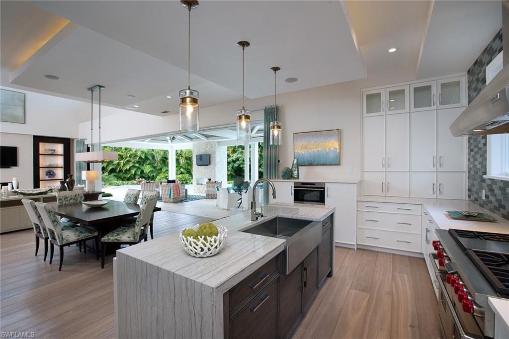 Perfectly positioned on a quiet cul-de-sac with an expansive, private outdoor oasis, this is truly Park Shore paradise. Exquisitely detailed by renowned designer, Lisa Ficarra, the coastal chic design is the ideal atmosphere to relax and unwind. Impressive, wide plank Legno Bastone floors seamlessly lead the eye to the serene covered outdoor area complete with fireplace, gourmet summer kitchen and a view of the resort like pool with spa, sun shelf and luscious greenery. The master suite leaves no luxury to be desired with custom Pecky Cypress and shiplap wall treatments, beautiful custom cabinetry and incredible walk through shower. With a stunning front elevation, 3 car garage, western exposure and close proximity to the Gulf Beaches, Venetian Village and downtown Naples, the idyllic Naples lifestyle is found. Residents of Park Shore will also benefit in the right to lease or purchase boat slips in the Venetian Bay Yacht Club.
