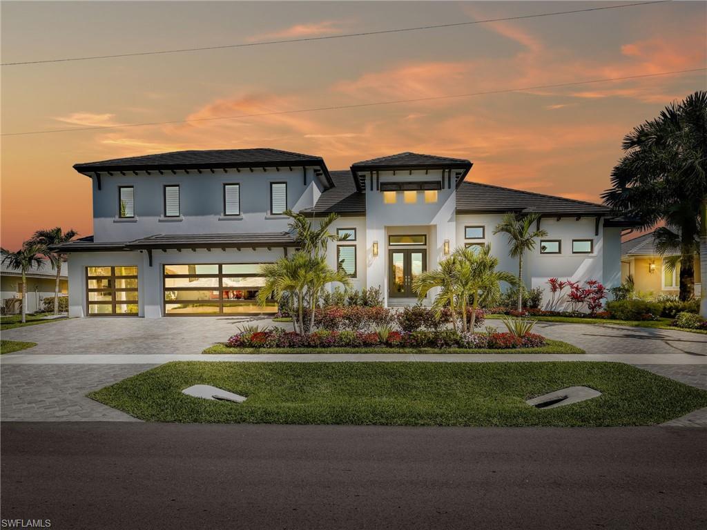 Experience the height of coastal luxury in this exquisite 2024 waterfront estate, ideally situated on Marco Island with coveted direct Gulf access. Designed to blend sophistication with effortless living, this remarkable home features 4 generously sized bedrooms, a versatile den/office, 4 full bathrooms, and a stylish powder room—all crafted with exceptional attention to detail and premium finishes.

Flooded with natural light from its sought-after southern exposure, the residence offers stunning water views and seamless indoor-outdoor living. The open-concept layout is highlighted by soaring ceilings, pocket glass sliders, and an elegant great room centered around a striking indoor gas fireplace—perfect for both intimate evenings and upscale entertaining.

The kitchen is a true showpiece, equipped with high-end appliances, custom cabinetry, and an oversized island that flows beautifully into the living and dining spaces, with a natural gas stove for elevated culinary performance.

Step outside to your private waterfront retreat, featuring a newer seawall and a picture frame pool screen that provides unobstructed views. The covered lanai, outdoor kitchen, outdoor gas fireplace, and generous lounge areas create an inviting setting for unforgettable sunsets and year-round enjoyment.

Upstairs, a spacious loft offers exceptional flexibility, complete with a stylish wet bar—ideal for a media room, home office, or additional living space.

Additional highlights include a 3-car garage featuring modern glass doors, impact-resistant windows and doors, and impeccable craftsmanship throughout. With a quick and direct Gulf access, boating enthusiasts will appreciate the unparalleled convenience and lifestyle this home provides.

This is refined waterfront living at its finest—where modern design meets timeless coastal elegance.