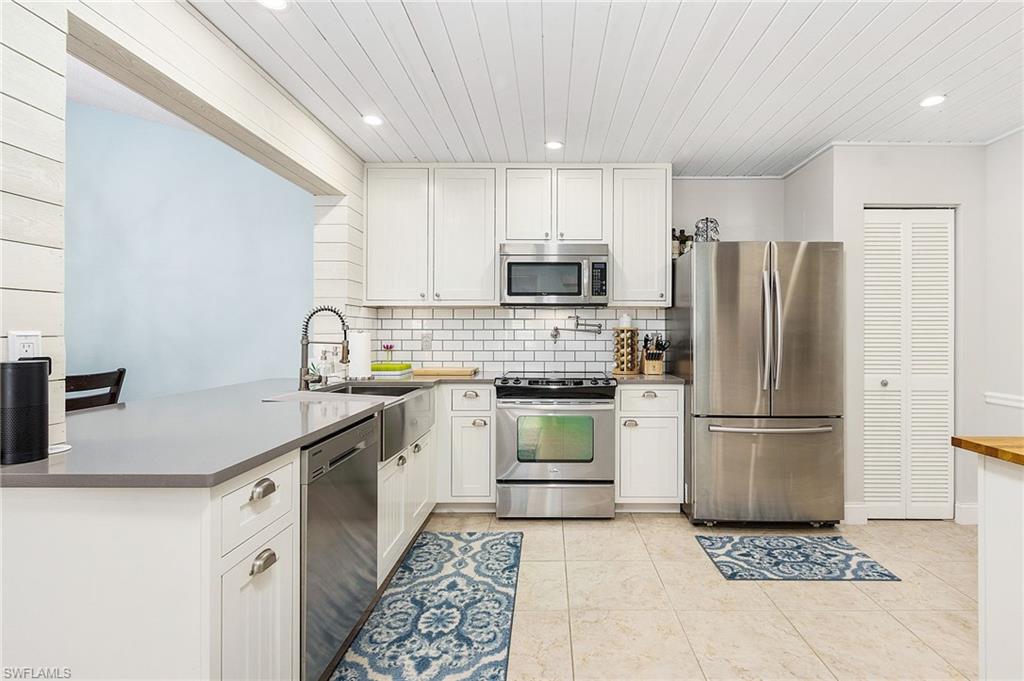 Fully remodeled large 3 bedroom 2 bath end unit with vaulted ceiling, a private preserve view, and covered parking. Located just 15 minutes from 5th Avenue South and Gulf beaches, and within walking distance to shopping and restaurants! New water heater 07/2020 and newer washer & dryer. Kitchen upgrades include custom cabinets, stainless steel appliances, quartz countertops, and recessed lighting. New flooring and fresh paint throughout the house. Newcastle residents have access to 2 community pools (one just seconds from the front door) and the Berkshire Lakes Clubhouse amenities (pool, kitchen, fishing pier, jogging/bike paths). Condo fees include water and cable.