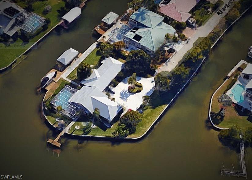 OVER 200' on the Bay! OUTSTANDING Bayfront Paradise Estate on a one-of-a-kind property with water views in every direction! Located at the end of the street, this gated residence offers a main home plus its own guest quarters. Lush tropical landscaping surrounding this magnificent property. Screened-in swimming pool overlooking the tranquil Estero bay. Watch the dolphins swim, and boats go by from your own living room! Two docks, boathouse with electric lift. Modern design and style with many updates including tile flooring, granite counter tops, stainless steel appliances and much more. If you're looking for a truly unique and private bay front residence... you've found it here. Don't miss this rare opportunity. Make sure you check out the Virtual tour and 3D floor plan. Recently price was reduced $200,000 ! This listing is now priced to sell!!