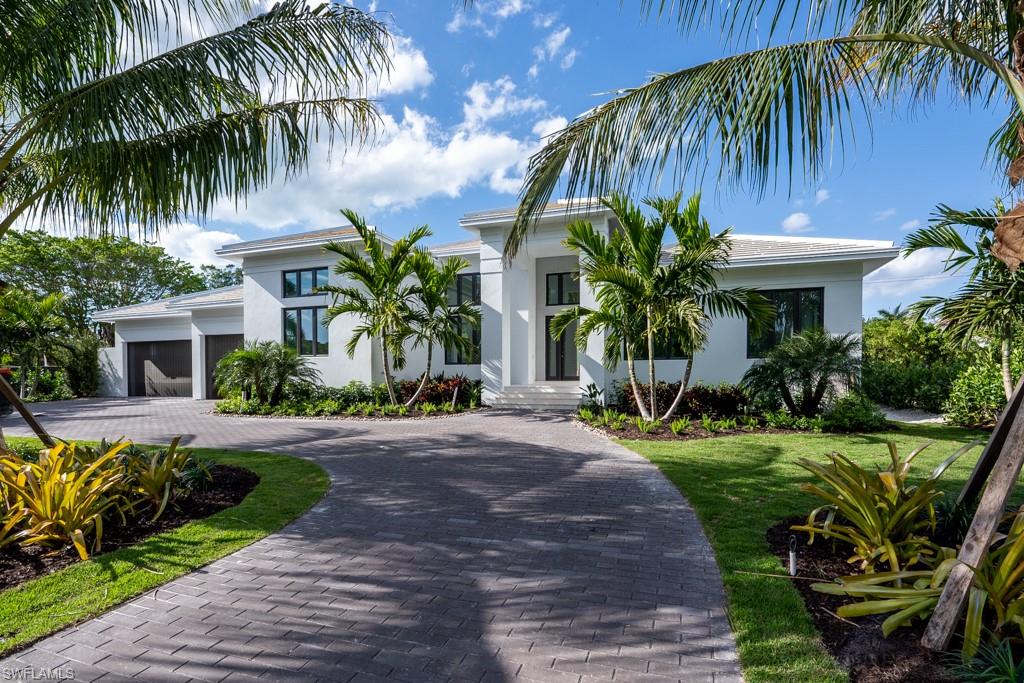 A brand new, one of a kind, custom design that presents a fantastic floor plan in the coastal community of Coquina Sands, and just a 12-minute walk to the beach.  Sited on nearly 17,000 sq ft of land, the modern design and spacious single level living pour in natural light with 16’ ceilings in main areas. The Living room, Social room, Dining, Kitchen, Study, and Owner’s Suite all face west with walls of 10’ pocketing sliders opening to the expansive sun deck and outdoor living that surround the custom pool and spa with two waterfalls, soaking in the sunshine, and displaying the resort style tropical landscaping. There is a VIP guest suite and three additional guest suites each with a unique designer styled bath. A dedicated powder bath and pool bath with storage, and spacious laundry room with views over the front landscape. Occupancy ready for April.