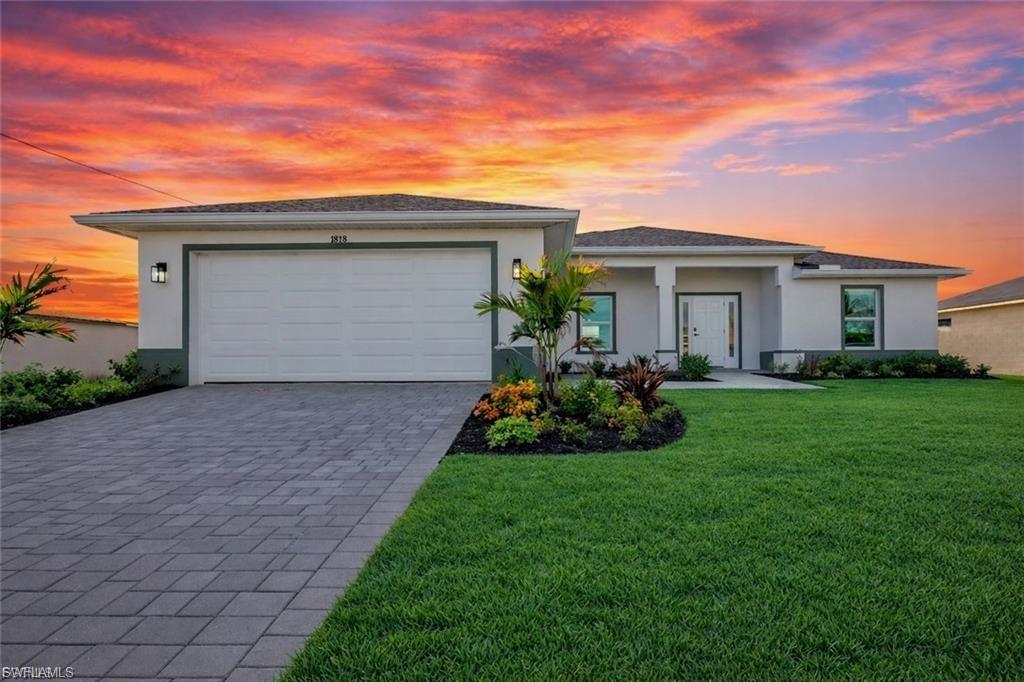 This like-new construction home offers four bedrooms and three full bathrooms with plenty of space for guests or a home office. Situated on a freshwater canal, the property provides a peaceful setting while remaining conveniently close to grocery stores, dining, and everyday essentials. The kitchen is designed for both function and style, featuring granite countertops, a large center island, white shaker cabinetry, and stainless steel appliances. Matching tile flooring runs throughout the home for a clean, cohesive look and easy maintenance. Impact-resistant windows and doors provide added security and peace of mind. Ideally located just a short drive to US-41, Pine Island Road, and Del Prado Boulevard, this home combines modern construction, canal-front living, and convenient access to shopping and major roadways. Not in a flood zone. Photos are from another model, same floor plan but finishes vary.